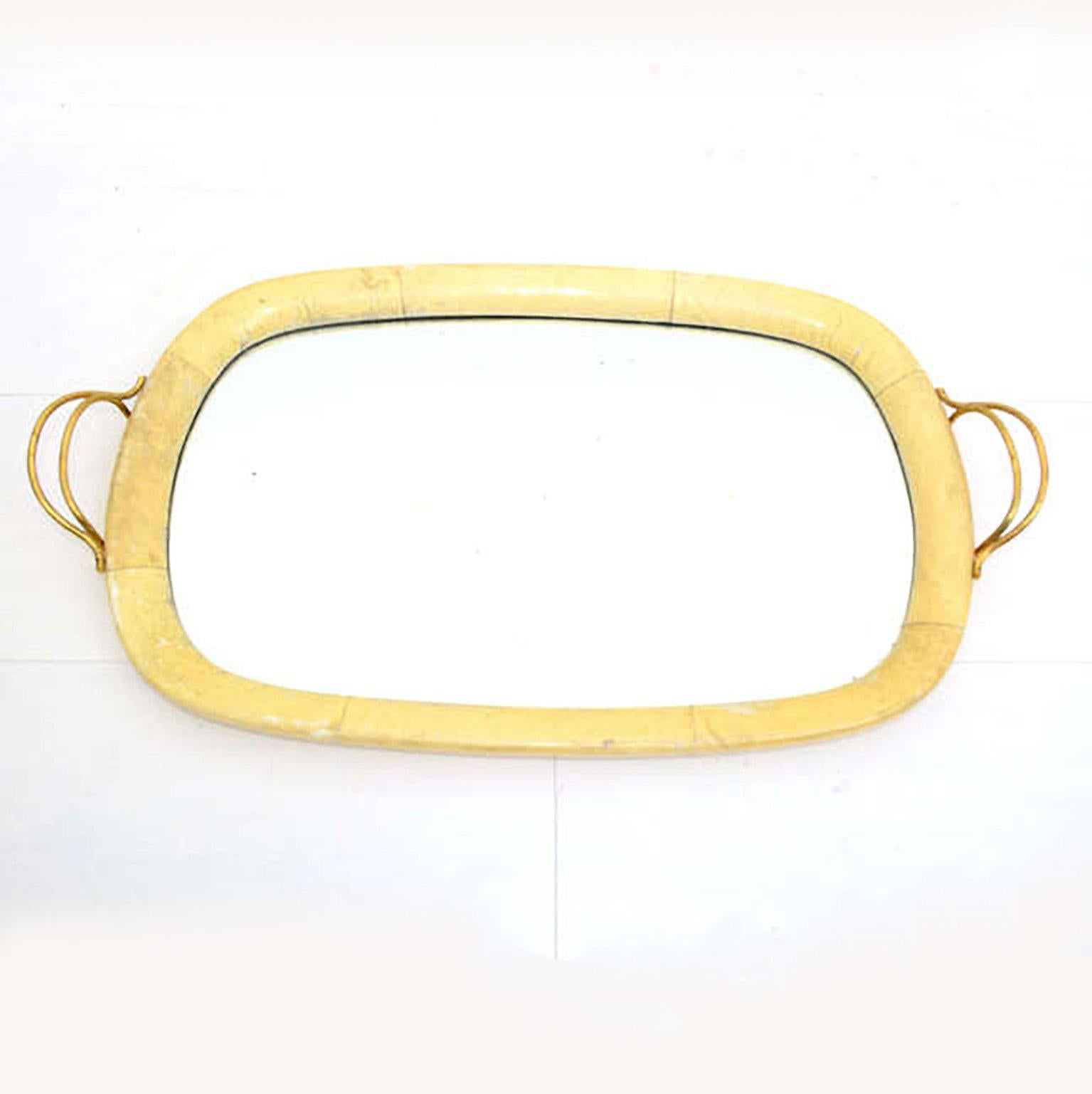 Aldo Tura made in Italy by Macabo 1950s 
Exquisite serving tray goatskin mirrored glass with sculptural brass handles
Original mirror.
Dimensions: 24W x 13.75 x 1.5H
Original unrestored vintage condition finish with patina is present. 
Parchment
