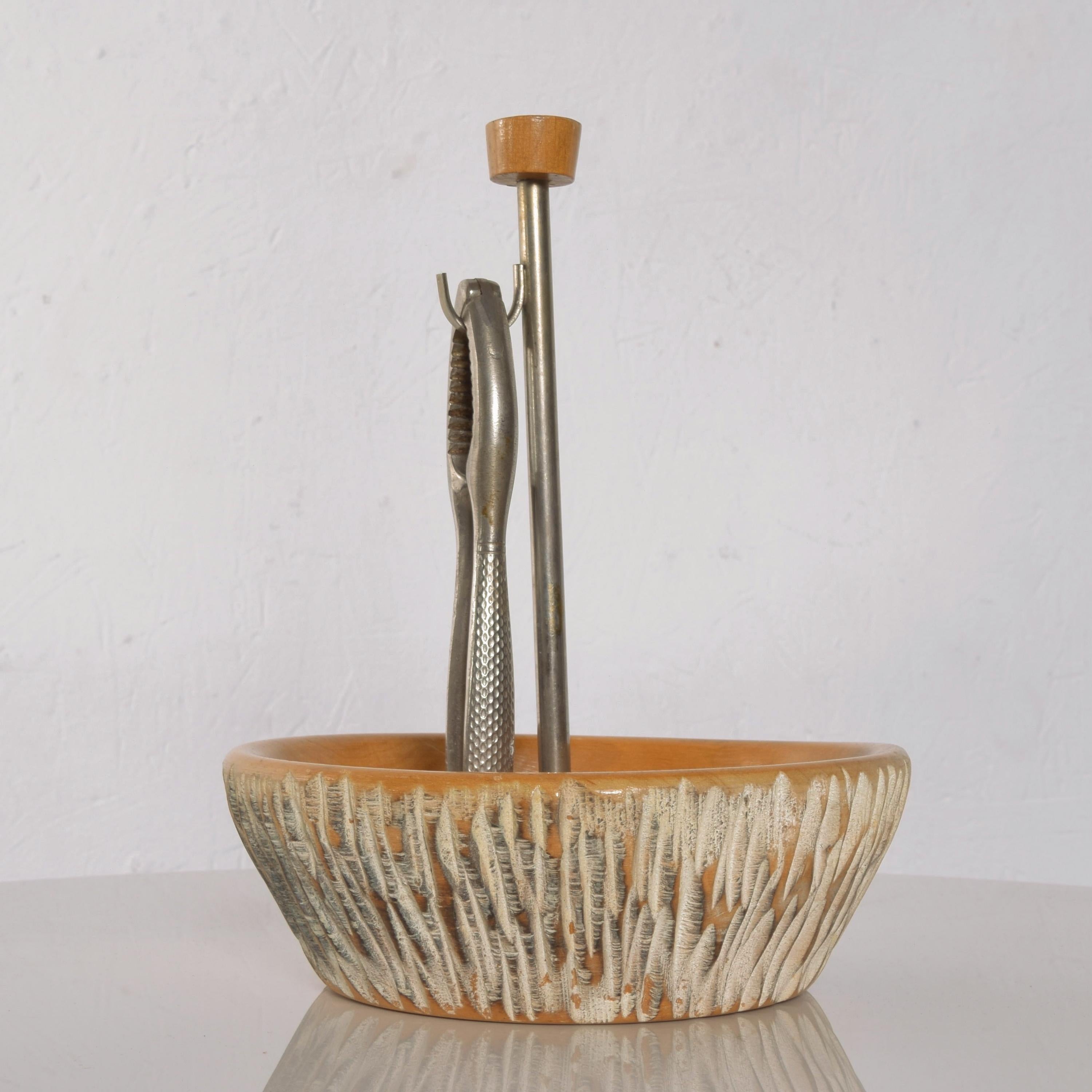Nutcracker Bowl
Italy Aldo Tura Macabo wood nutcracker dish with stainless steel tool 1960s
Measures: 8 1/2