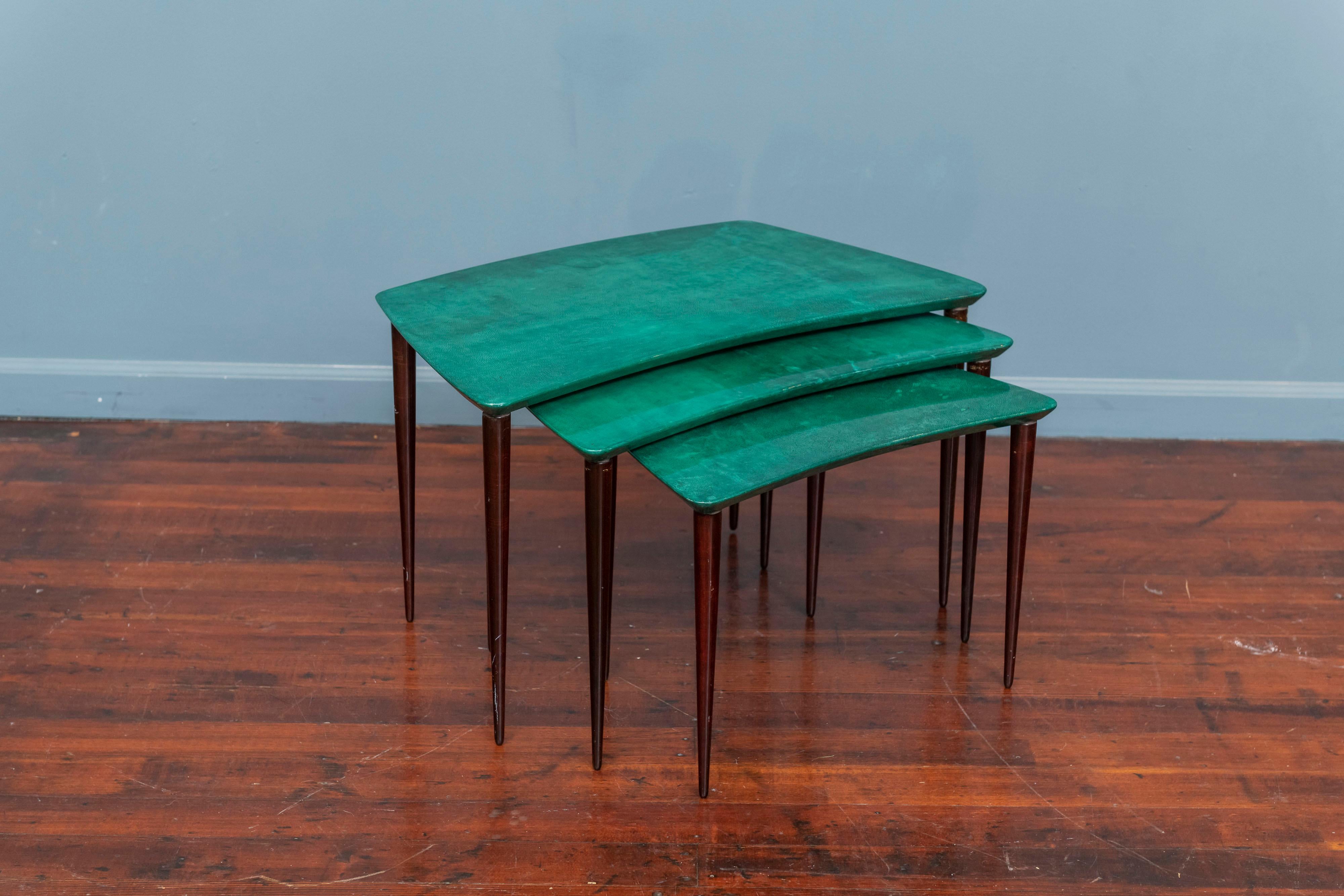 Set of three Aldo Tura nesting tables in lacquered goatskin and tanned pearwood legs. This particular set was executed in a rare malachite color, circa 1960 and is in great condition. Along with artists like Piero Fornasetti and Carlo Bugatti, Aldo
