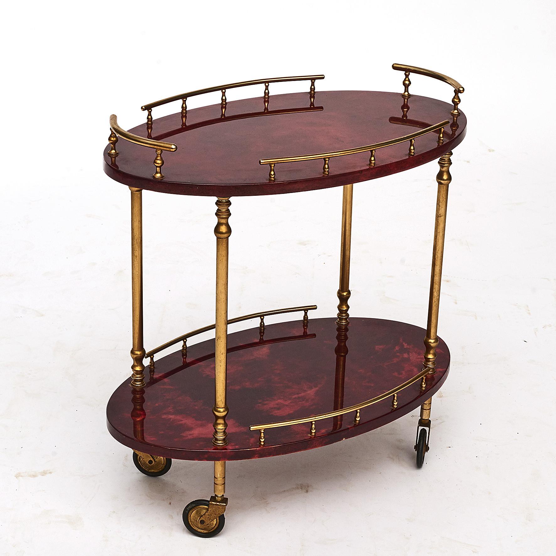 Bar cart / tea trolley, Italian design by Aldo Tura, 1950s.
Brass structure.
Surface with goat skin cover and clear varnish.
Italy, 1950-1953.

  