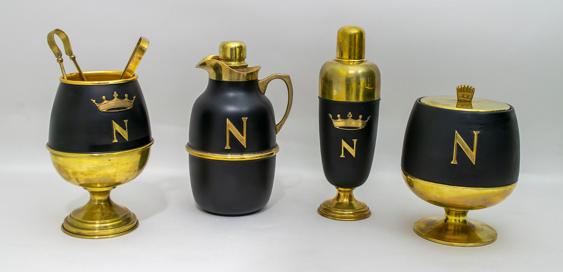 This cocktail set in brass and black lacquered brass was designed by Aldo Tura Macabo for Napoleon Cognac and produced in Italy by standard by Cusano Milanino. The set includes a bucket for ice pliers, a thermos, a cocktail shaker and an ice bucket.