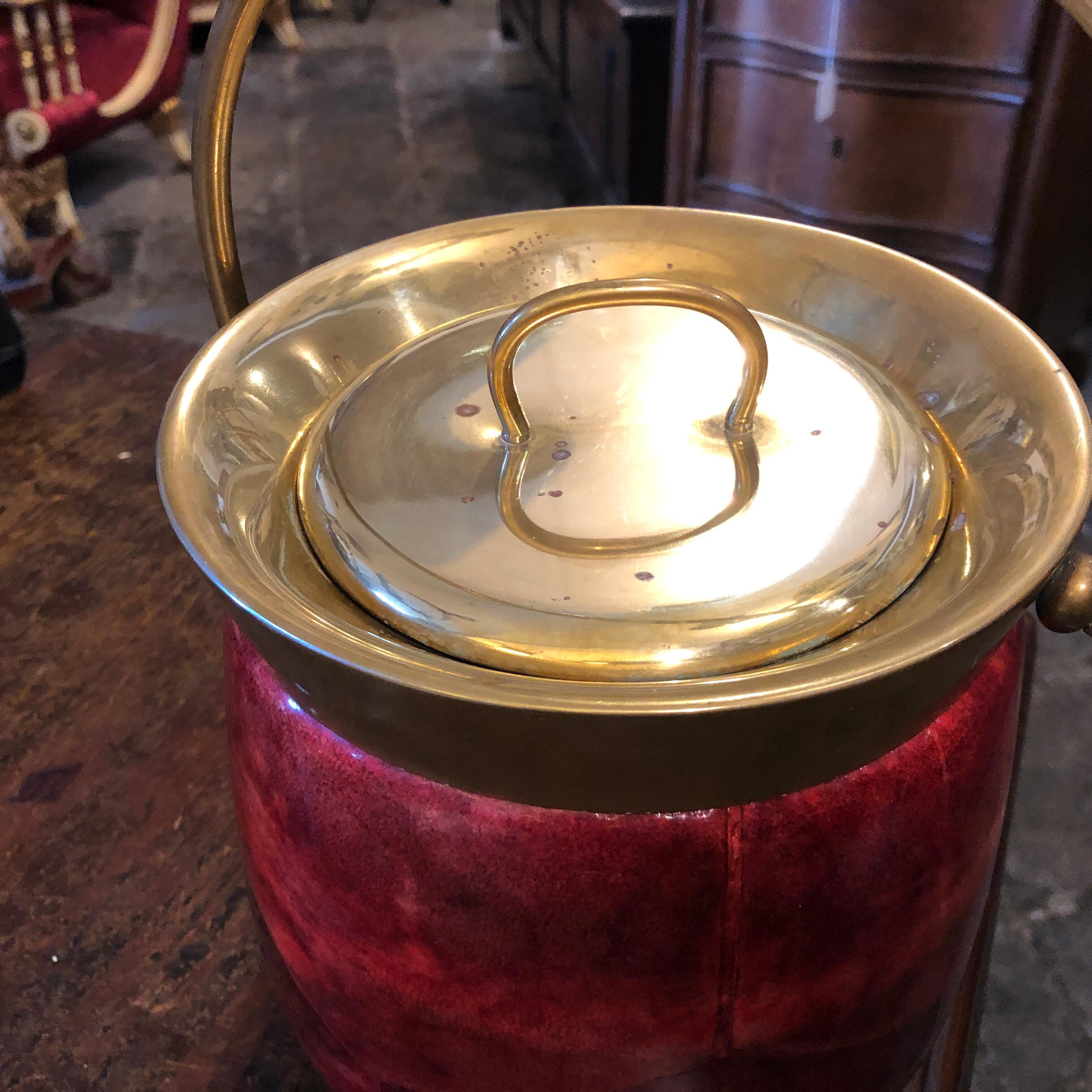 An iconic ice bucket designed by Aldo Tura, made in Italy in the Fifties, it has a little break in the inside glass visible in a photo.