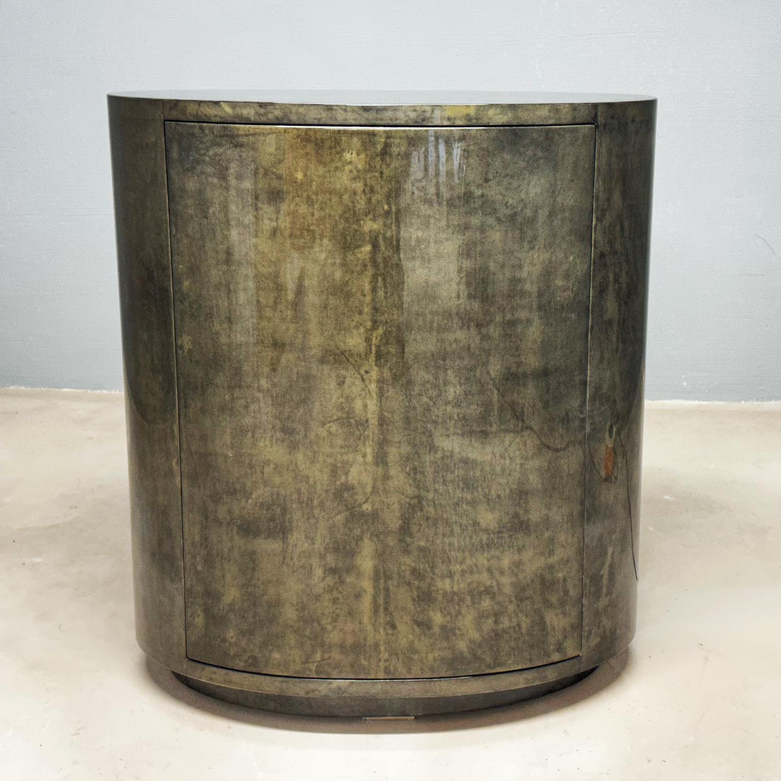 Very rare and magnificent Aldo Tura goatskin oval bar cabinet in a wonderful grey green muddy color was designed in Italy, circa 1970s. The exceptional clear small bar cabinet is illuminated and mirrored inside with an oval glass shelfs, has an