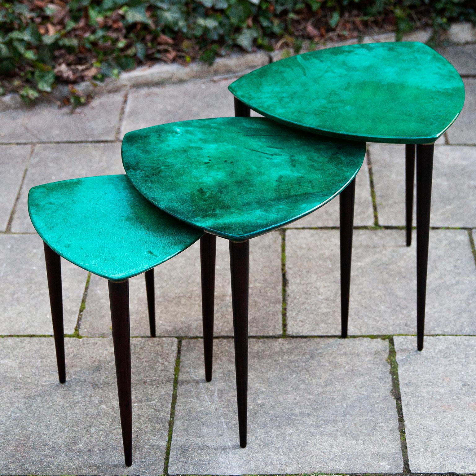 Elegant set of three nesting tables made by Aldo Tura, Italy in the 1960s.

The nesting tables was executed in lacquered green goatskin and they are in excellent condition.

Along with artists like Piero Fornasetti and Carlo Bugatti, Aldo Tura