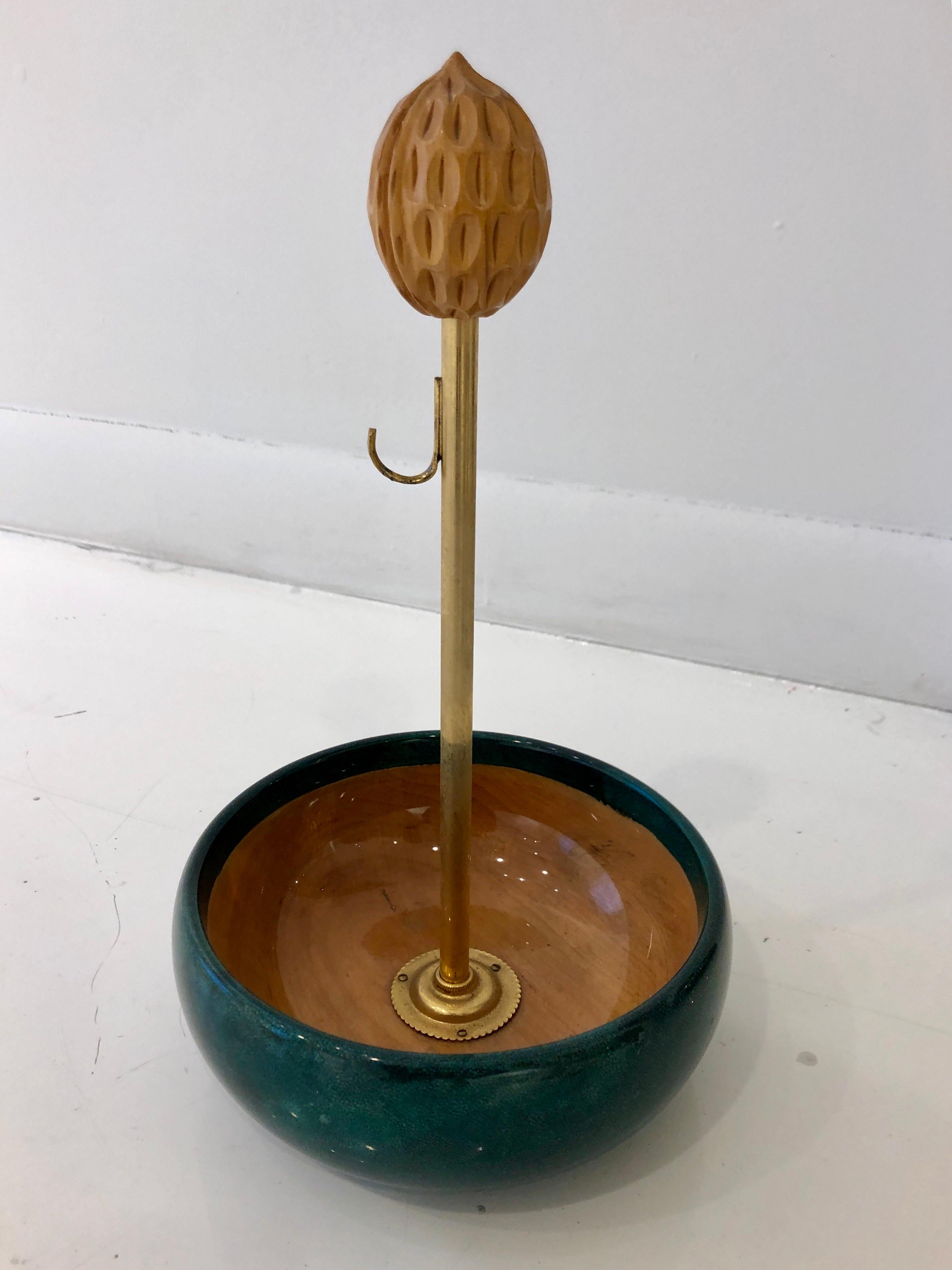 Whimsical nut bowl as sculpture. Green velum wrapped mahogany bowl with 24-karat gold gilded brass stem and nutcracker with carved walnut finial.