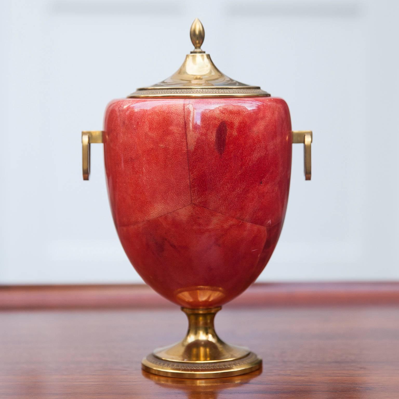 Wonderful Aldo Tura ice bucket in light red colored goatskin with brass applications and glass inlay made in the 1960s.