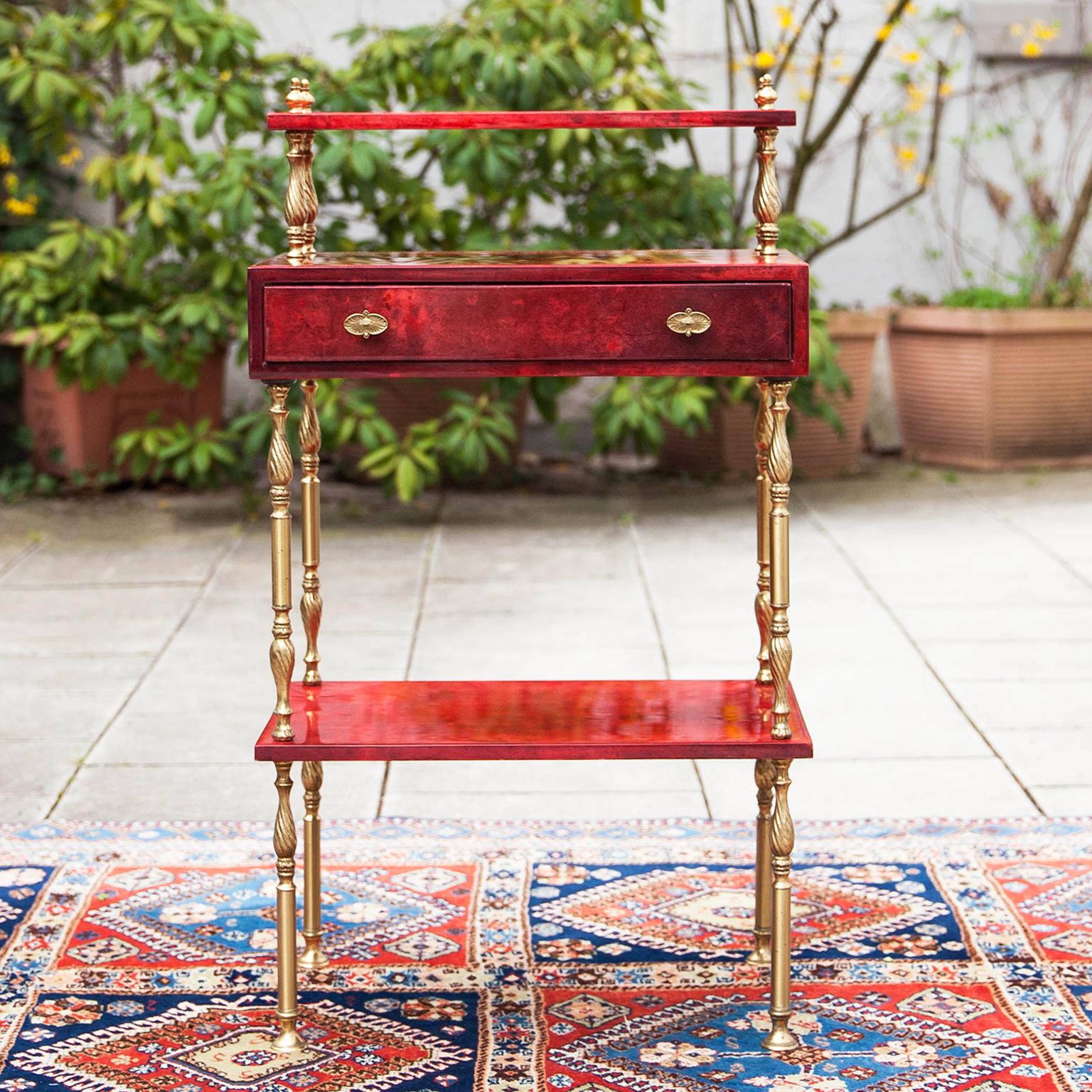 Aldo Tura red goatskin parchment side table or night stand with one drawer. This wonderful elegant piece of Italian living culture consisting to three levels and a drawer. Nice brass details.
This particular table was executed, circa 1960 and is in