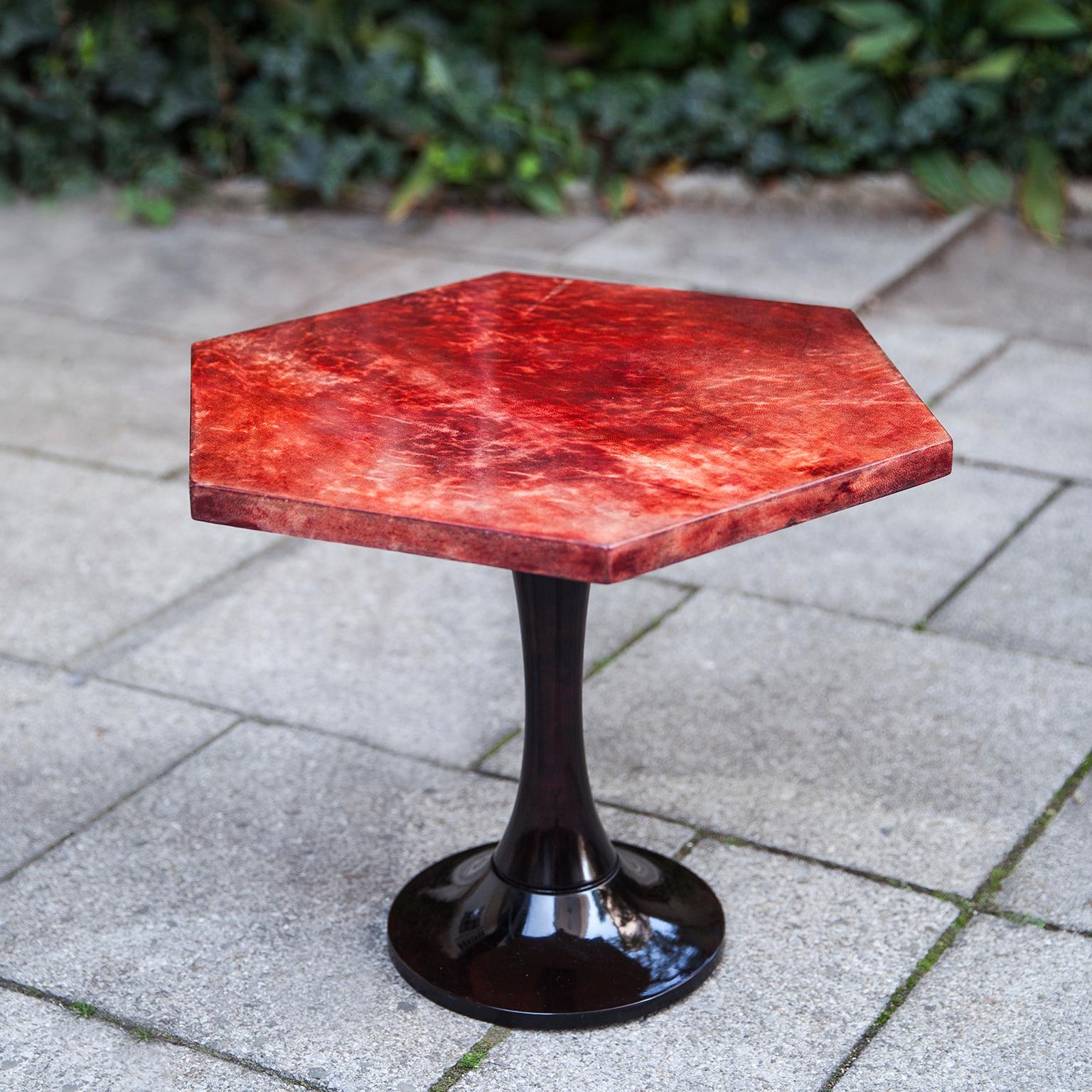 Wonderful hexagonal side table of Aldo Tura in lacquered goatskin.
This side table was executed, circa 1960 in a red parchment and mahogany base. Along with artists like Piero Fornasetti and Carlo Bugatti, Aldo Tura (1909-1963) definitely belonged