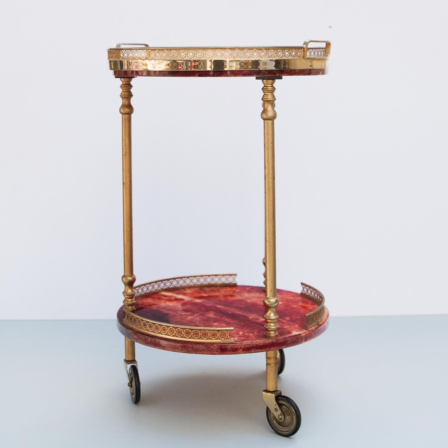 Fine bar or serving cart by Aldo Tura Milan, Italy 1960s.

The wooden frame is covered with red colored goatskin, varnished in clear acrylic lacquer and polished brass with a removable glass tray.

This particular coffee table was executed, circa