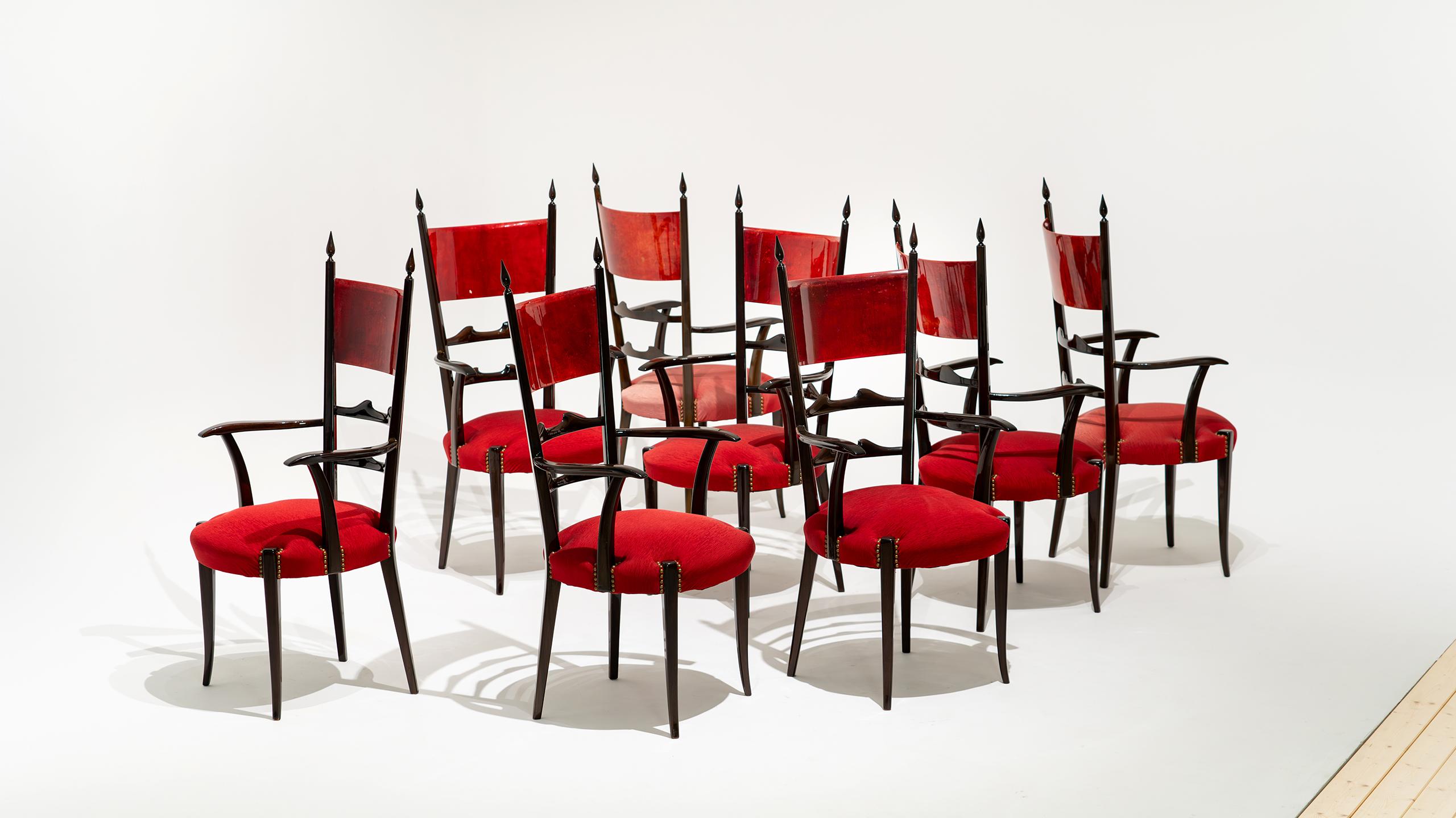 A set of 8 tall ladder-back dining chairs by Aldo Tura, 1962 for Atélier Tura.

The chairs frames are made of gloss wood and the backrests feature red lacquered goatskin parchment applied on both front and back.

120cm high, 45cm wide, 46cm deep and