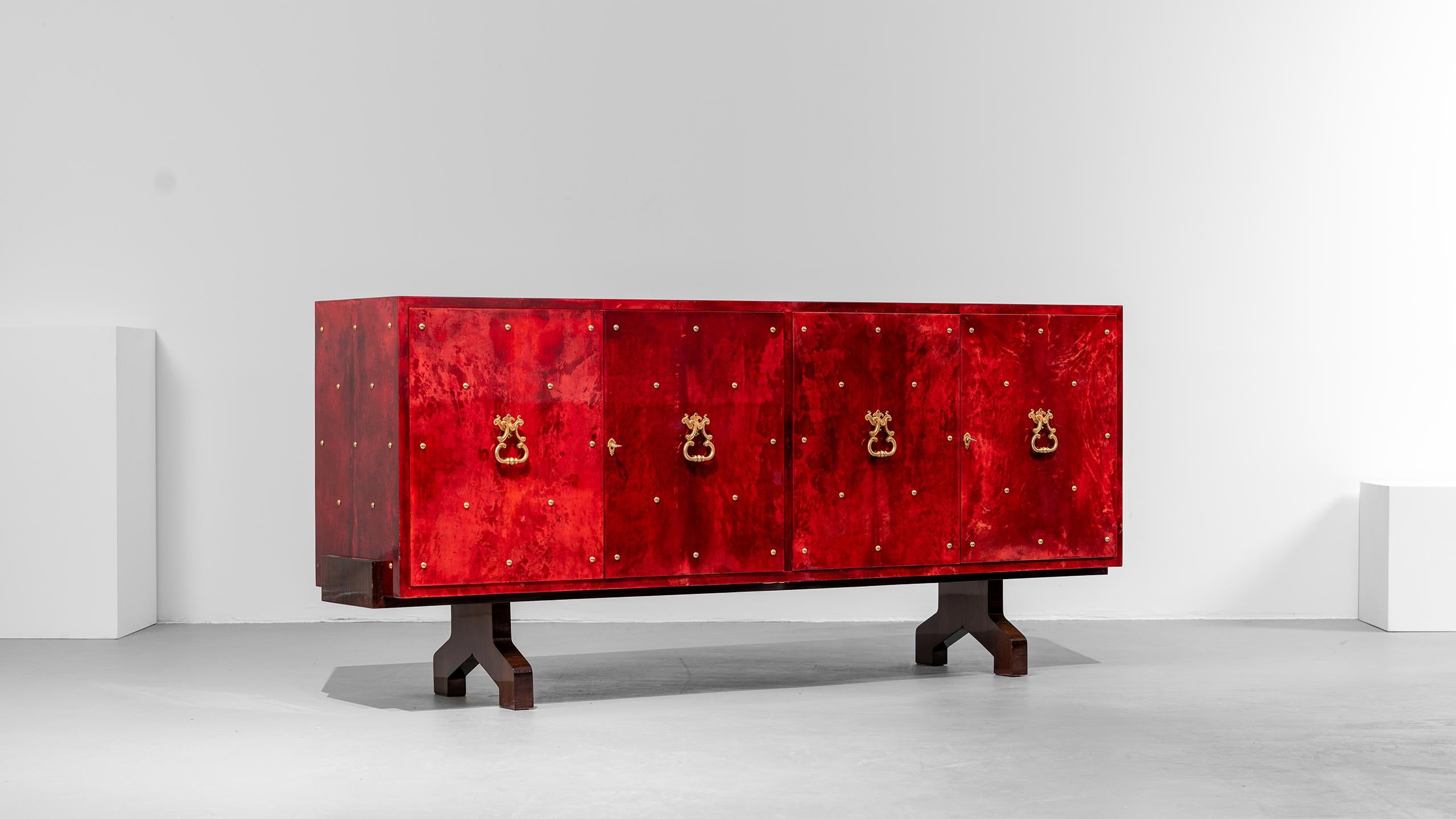Buffet incroyablement impressionnant en peau de chèvre laquée dans une chaude nuance de rouge, 
conçu par Aldo Tura en Italie en 1962.

A droite, il comporte 5 tiroirs, à côté desquels se trouve un compartiment avec une tablette en verre. A gauche,