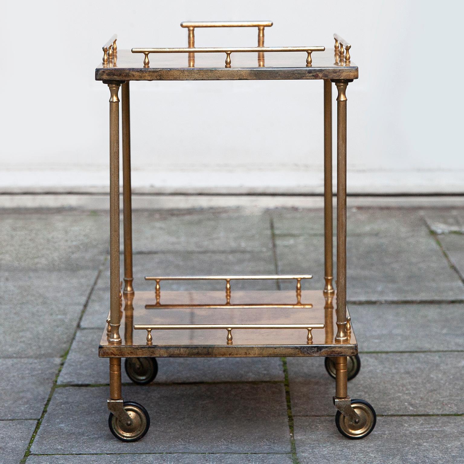 Wonderful serving cart made by Aldo Tura, Italy in the 1960s.

The bar cart was executed in lacquered light brown goatskin with brass applications and it is in nearly excellent condition.

Along with artists like Piero Fornasetti and Carlo