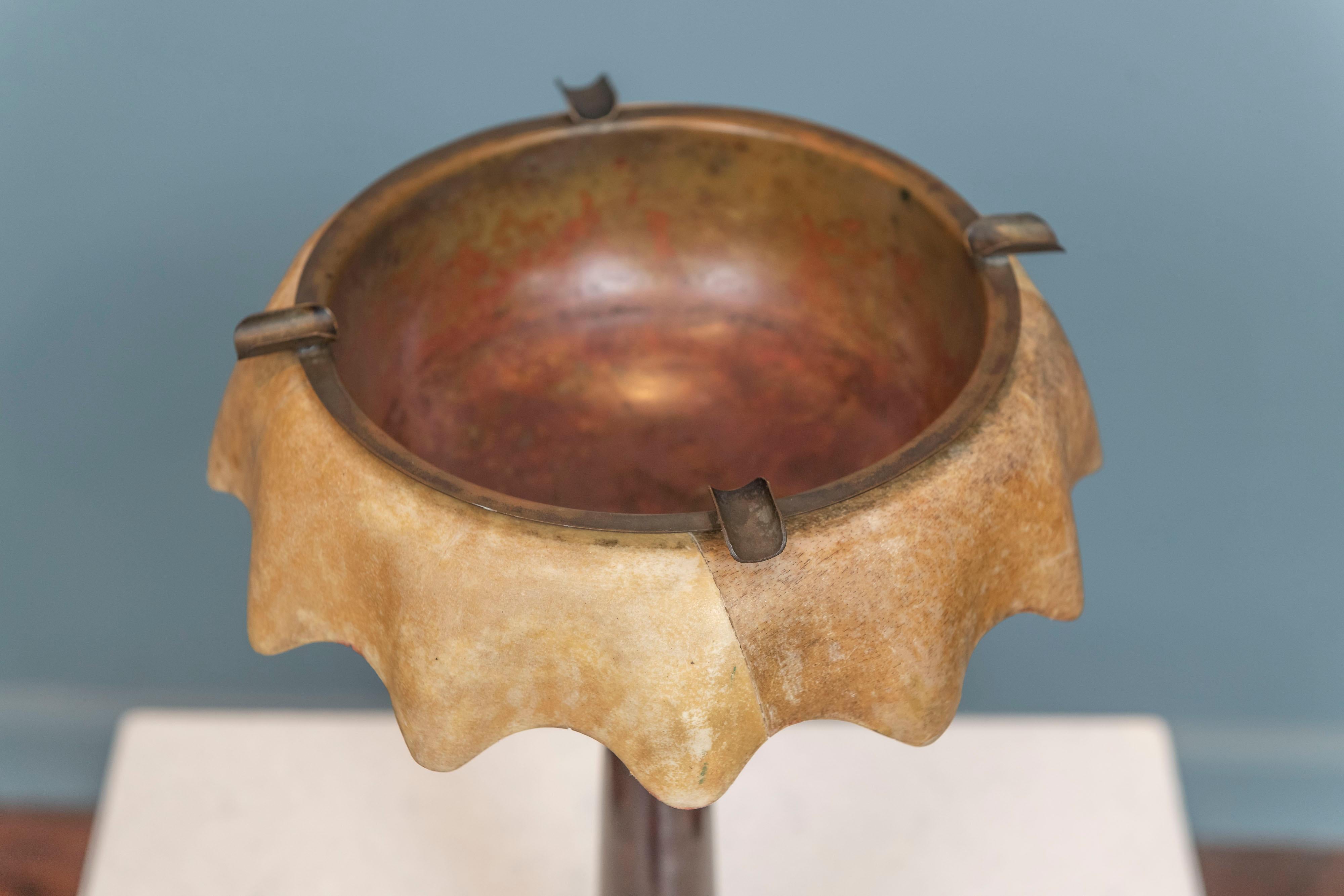 Aldo Tura smoking stand made from stained fruitwood and a scalloped parchment covered top. 
A patinated nickel and copper plated ashtray with cigarette holders fits snugly into the top of the stand.