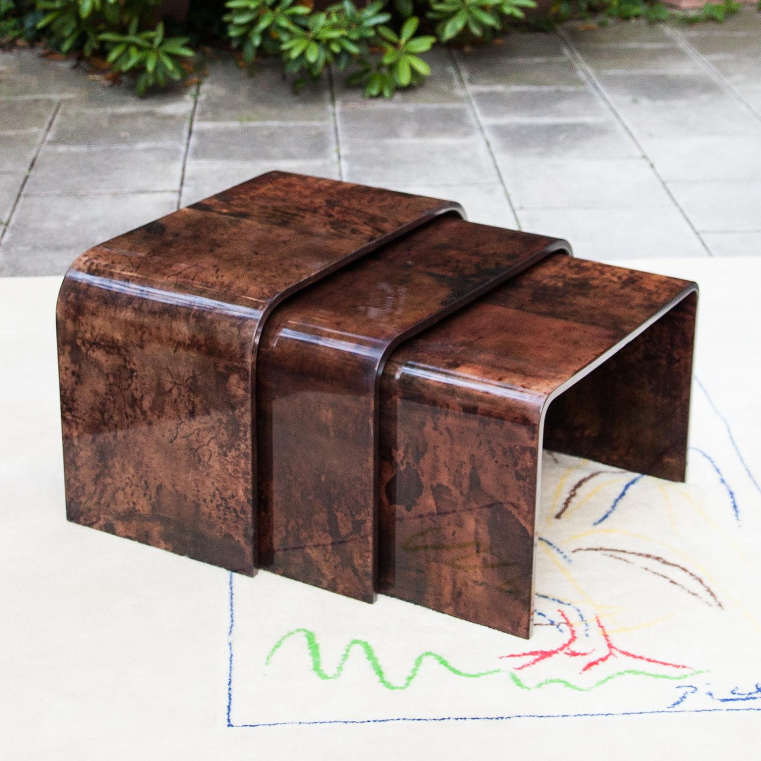 Set of three Aldo Tura nesting tables in brown lacquered goatskin and executed circa 1975 in a somewhat soft style, but – as strong contrast – is covered with a brown tanned parchment. Along with artists like Piero Fornasetti and Carlo Bugatti, Aldo