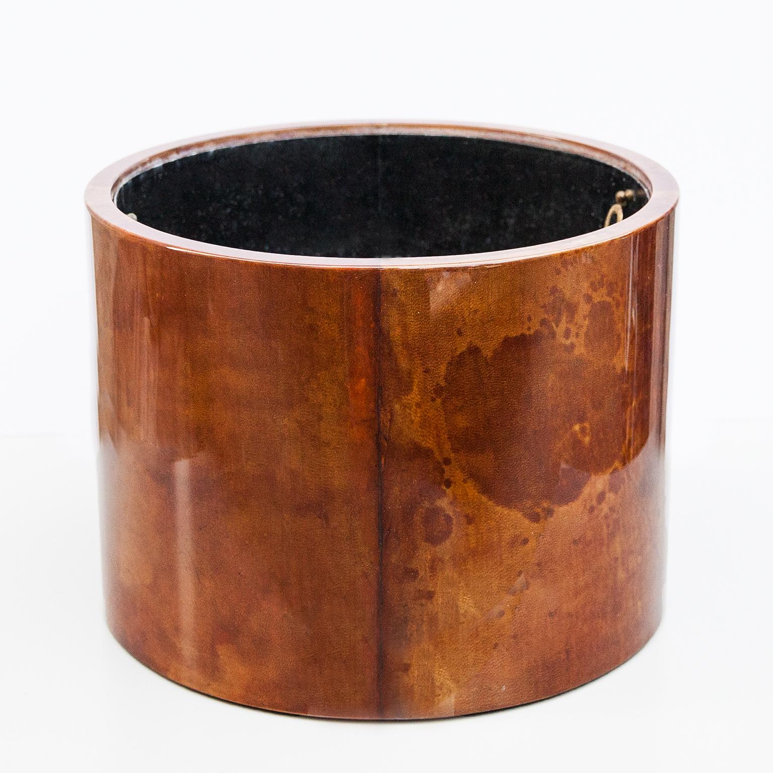 This elegant Aldo Tura planter has a wooden frame covered with tobacco color goatskin, varnished in clear acrylic lacquer.

This particular planter was executed, circa 1980 and is in perfect condition. Along with artists like Piero Fornasetti and