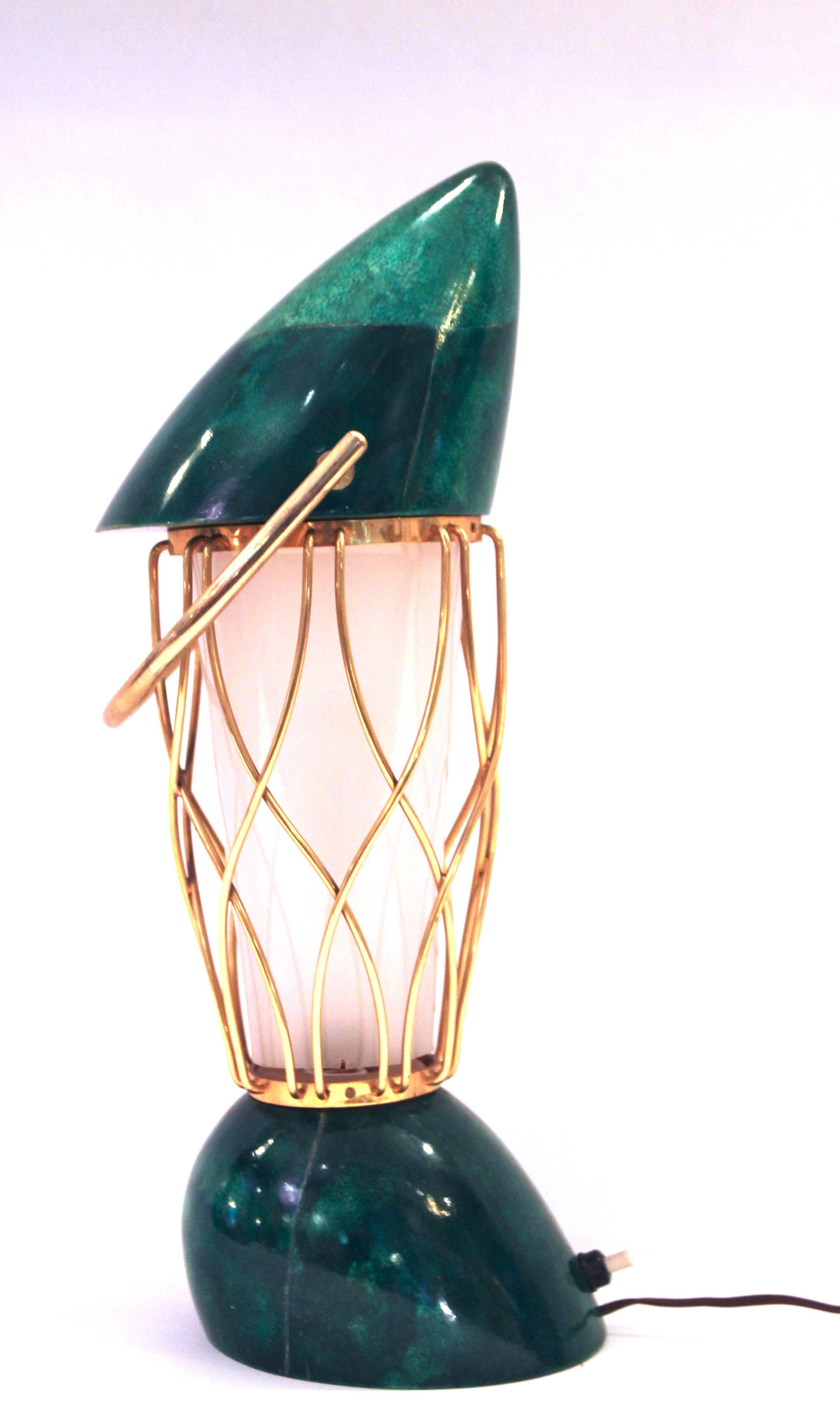 Aldo Tura, table lamp, 
stamped with logo: A.TURA, MILANO,
 green lacquered parchment decorated and style malachite, 
Handle and gilt brass cage and plastic Lampshade,
circa 1960, Italy. 
Height: 40 cm, diameter 15 cm.