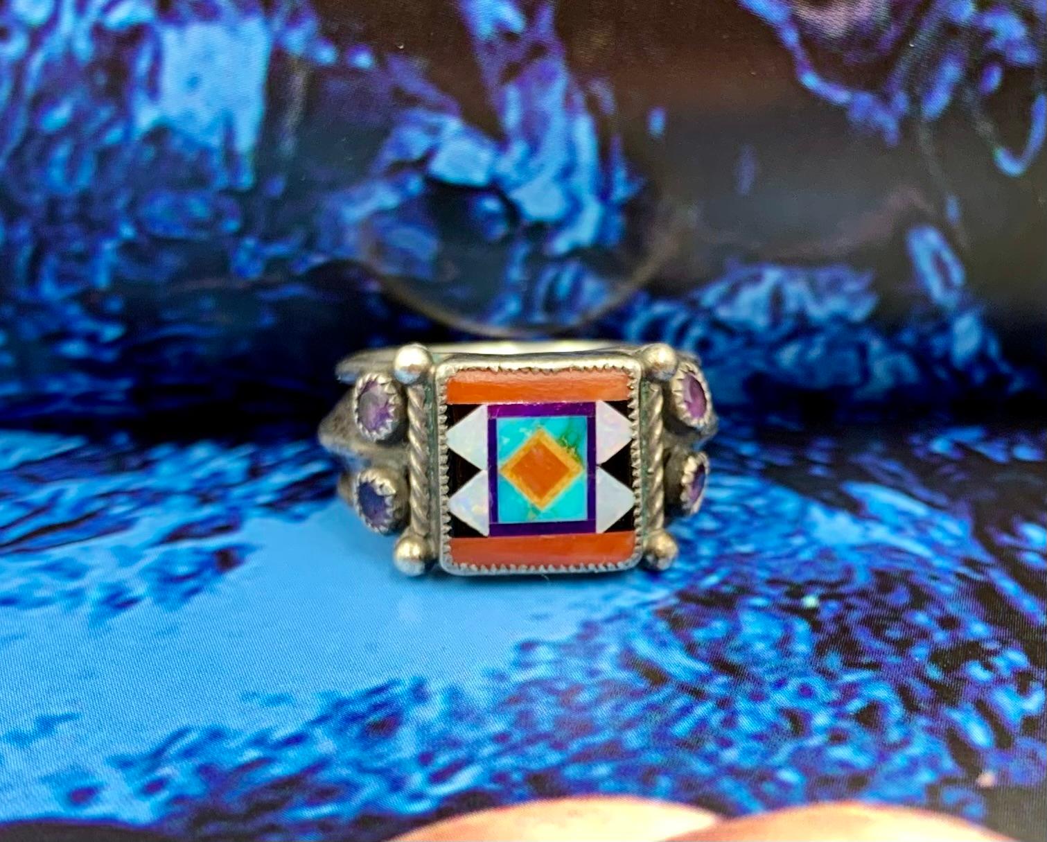 Southwestern Style Aldrich Art inlaid opal, turquoise, jet, lapis lazuli, coral and faceted amethyst sterling silver ring
20th Century
Provenance: estate of a notable New York City psychiatrist and artistic, often one-of-a-kind jewelry