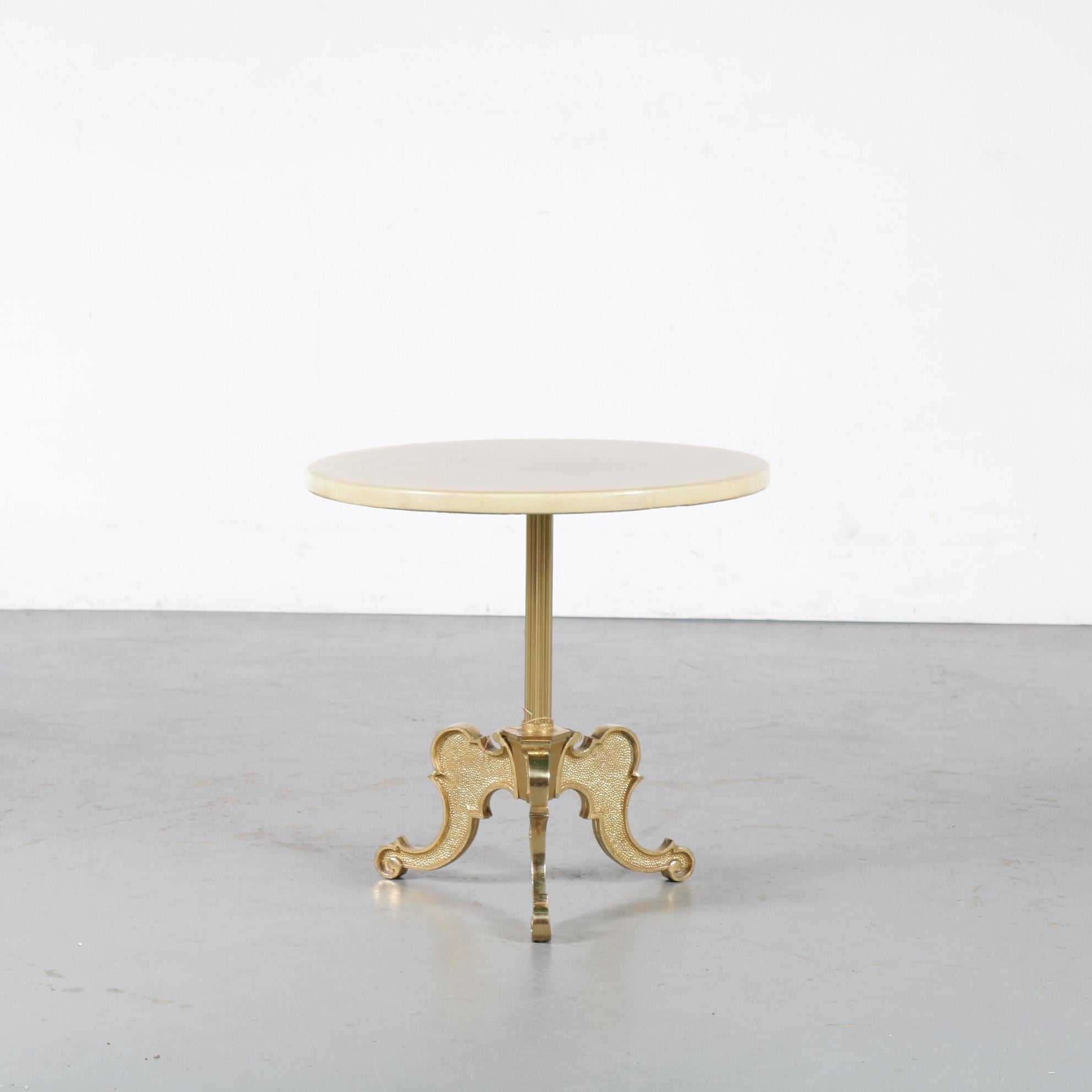 A beautiful side table or coffee table by Aldo Tura, manufactured in Italy around 1960.

This elegant piece is made of high quality brass with beautiful curved shapes, giving it a most luxurious appearance! The round top is made of goat skin,