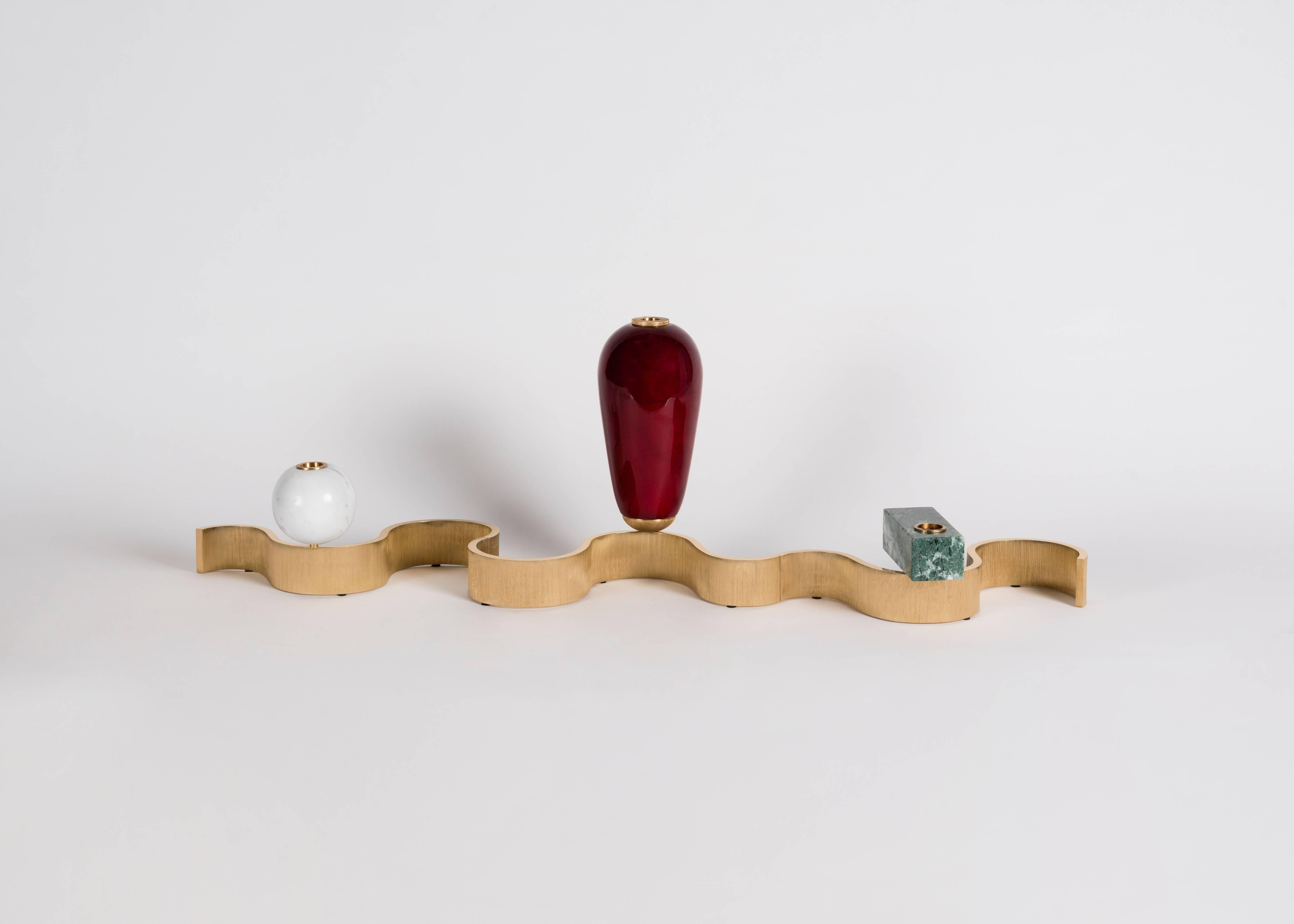 A centerpiece in three elements - one a parchment clad vase and the other two candlesticks of stone, all set upon connecting, serpentine cast brass bases. Edition of 20 pieces.

A collaboration between Achille Salvagni and Fabio Gnessi, Aldus aims