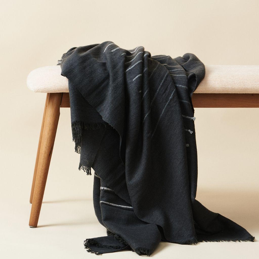 Custom design by Studio Variously, ALEI  throw / blanket is handwoven by master weavers in Nepal and dyed entirely with earth-friendly dyes & soft merino yarn that is hand spun. A sustainable design brand based out of Michigan, Studio Variously