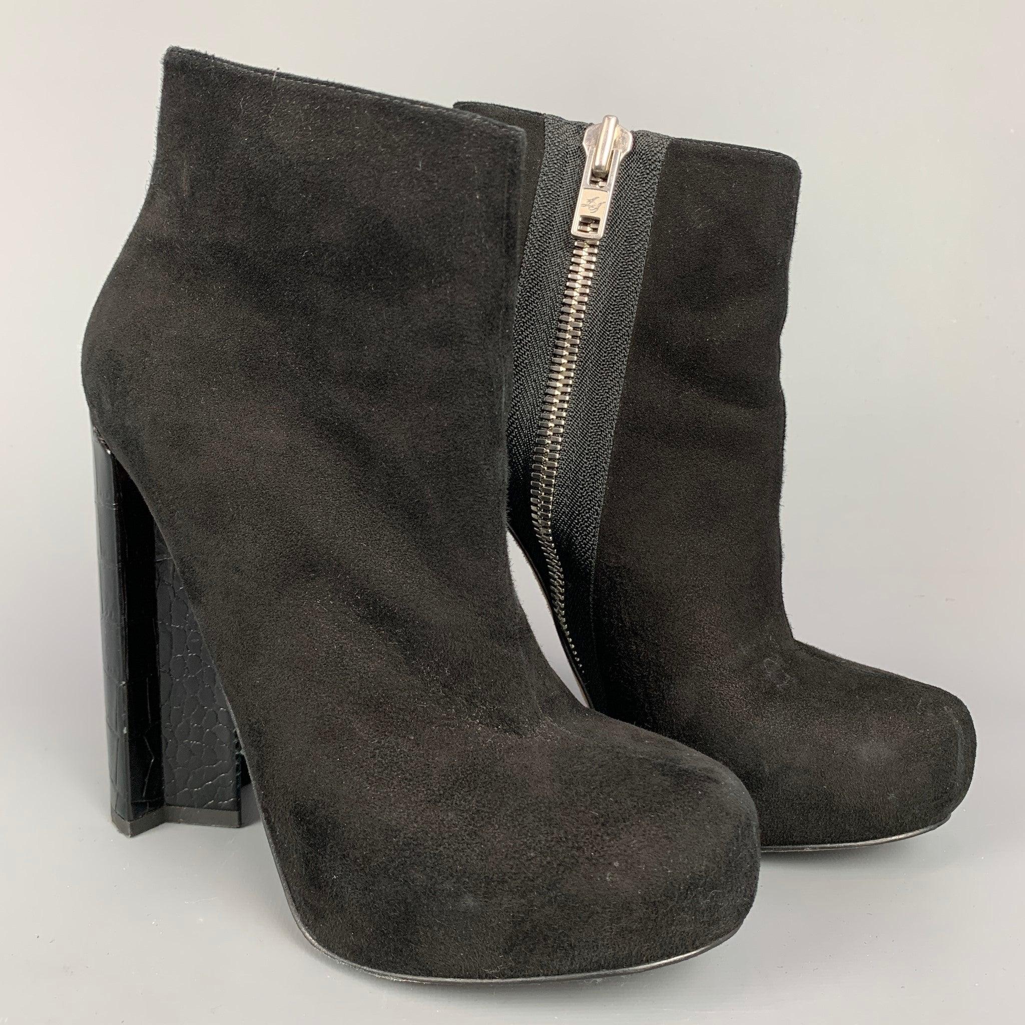 ALEJANDRO INGELMO ankle boots comes in a black suede featuring a platform style, chunky heel, and a side zipper closure.
Very Good
Pre-Owned Condition. Light wear at heel. 

Marked:   36.5  

Measurements: 
  Length: 7.5 inches  Width: 2.5 inches 