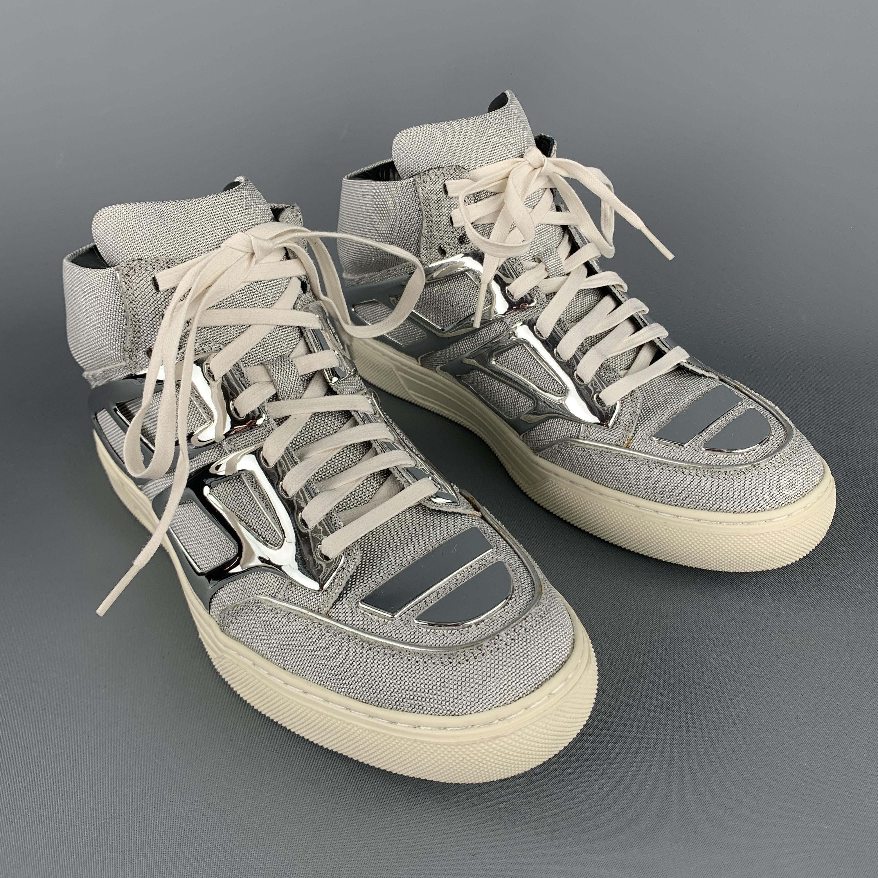 ALEJANDRO INGELMO Tron metallic high top sneakers comes in silver tones, metallic canvas and plastic material, with a white lace and rubber sole. 

New with Box.
Marked: 8M
Original Retail Price: $550.00

Outsole: 11 x 4 in.