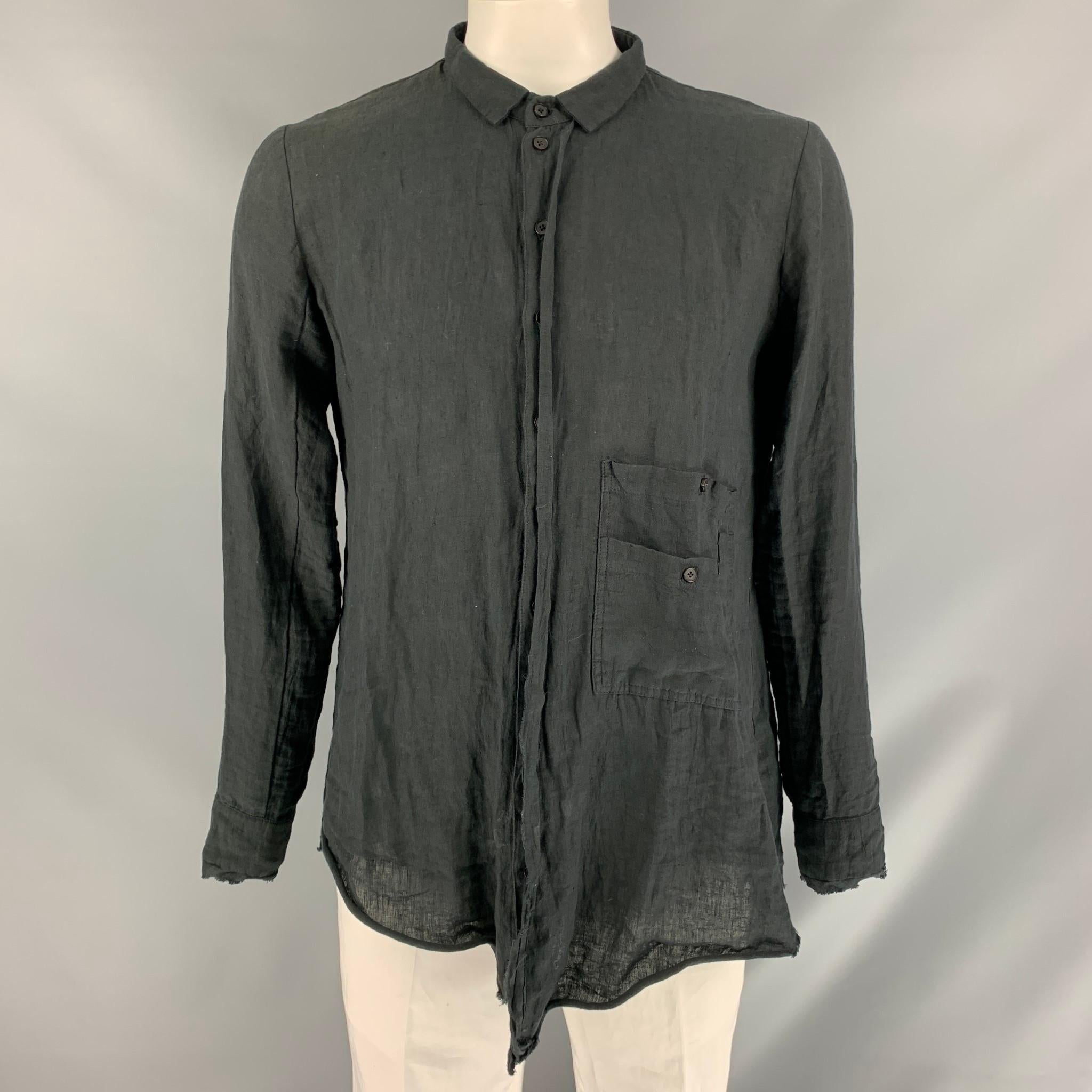 ALEKSANDR MANAMIS  asymmetrical long sleeve shirt comes in solid black linen with straight neckline, button down front closure, two button square cuff and double patch pocket at bottom left side. Made in Denmark.

Excellent Pre-Owned