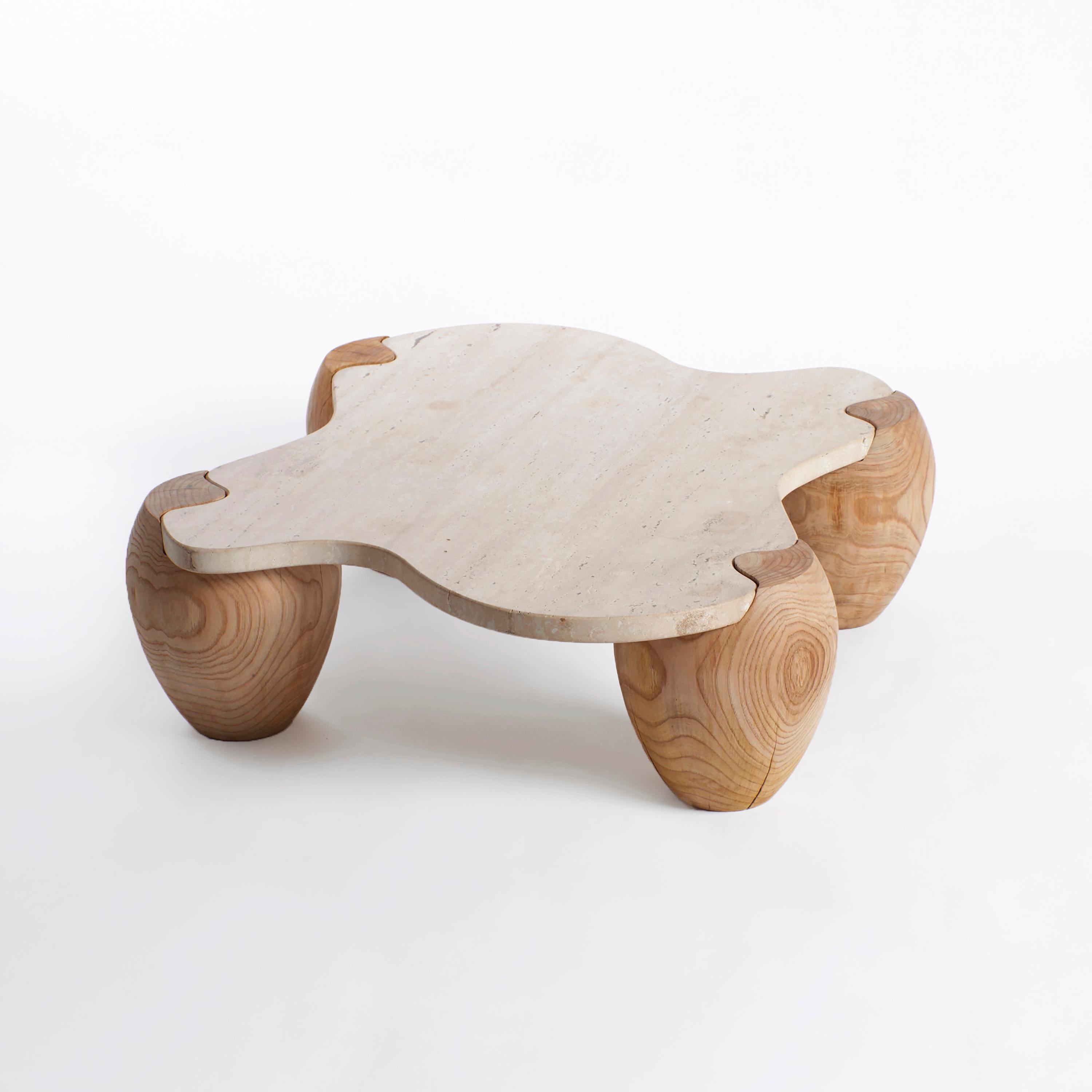 Alentejo Coffee Table by Project 213A
Dimensions: W 120 x D 93 x H 28 cm
Materials: Chestnut, Travertine.

This organic-shaped coffee table stands is made from Travertine and assembles like a puzzle onto the four wooden legs. Each legs is made from