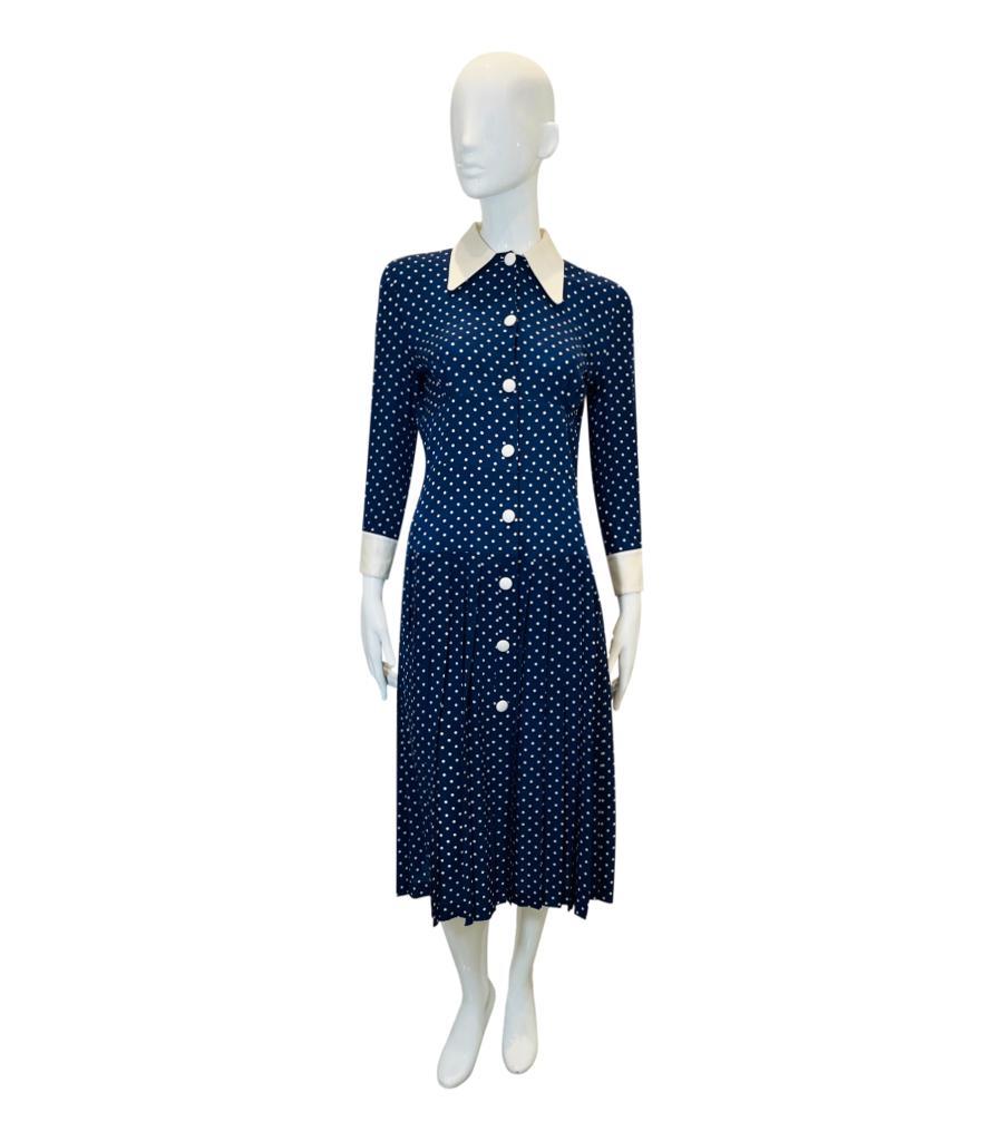 Alessandra Rich Silk Pleated Polka-Dot Dress
Navy midi dress designed with polka-dot pattern and white shirt inspired collar.
Featuring white cuffs in three-quarter sleeves, centre button closure and pleated A-Line skirt.
Seen on Kate