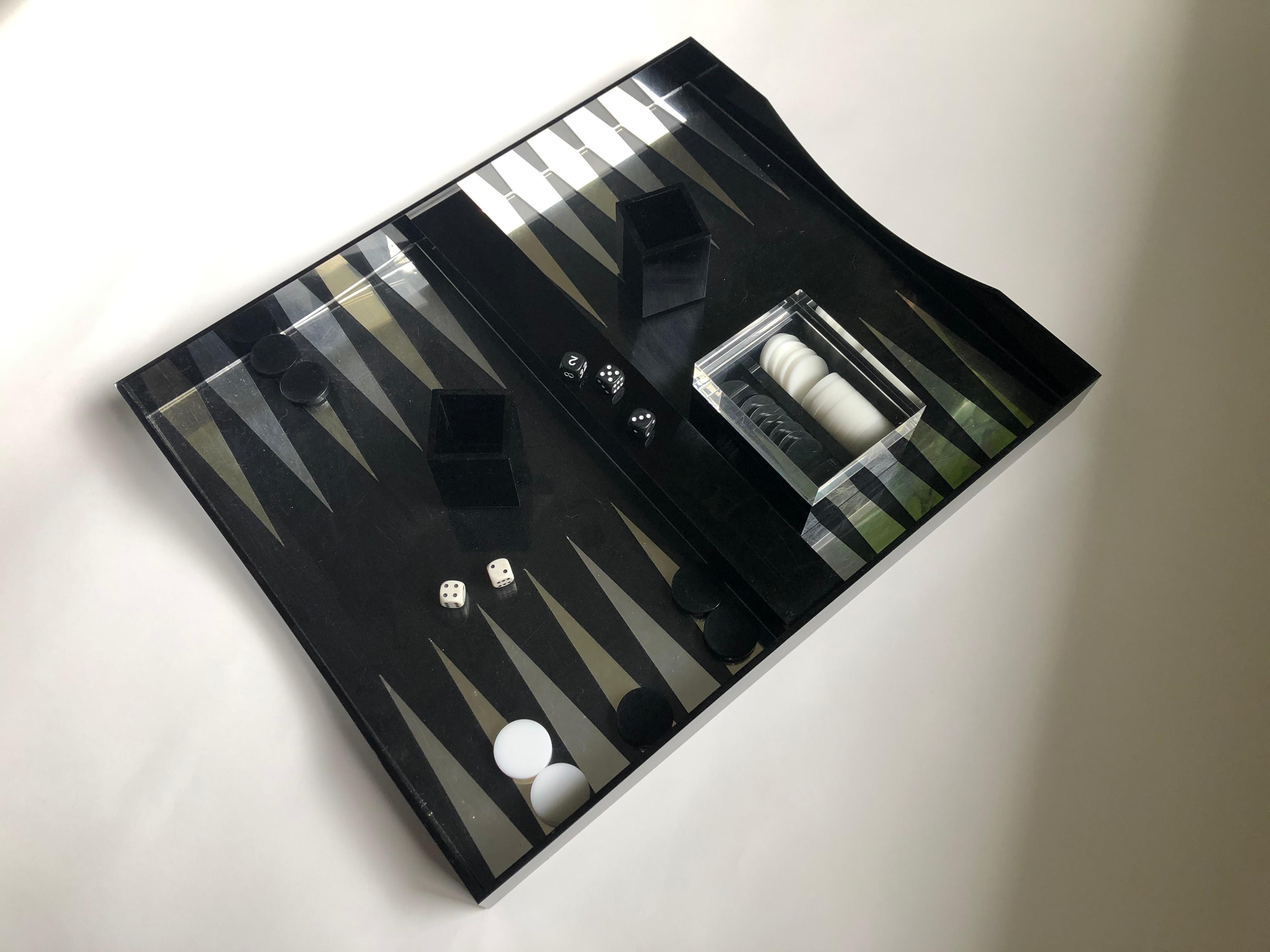 Complete vintage modern black Lucite backgammon set designed by Alessandro Albrizzi includes game board, a thick Lucite box for the Bakelite chips, two Lucite dice cups, and dice.