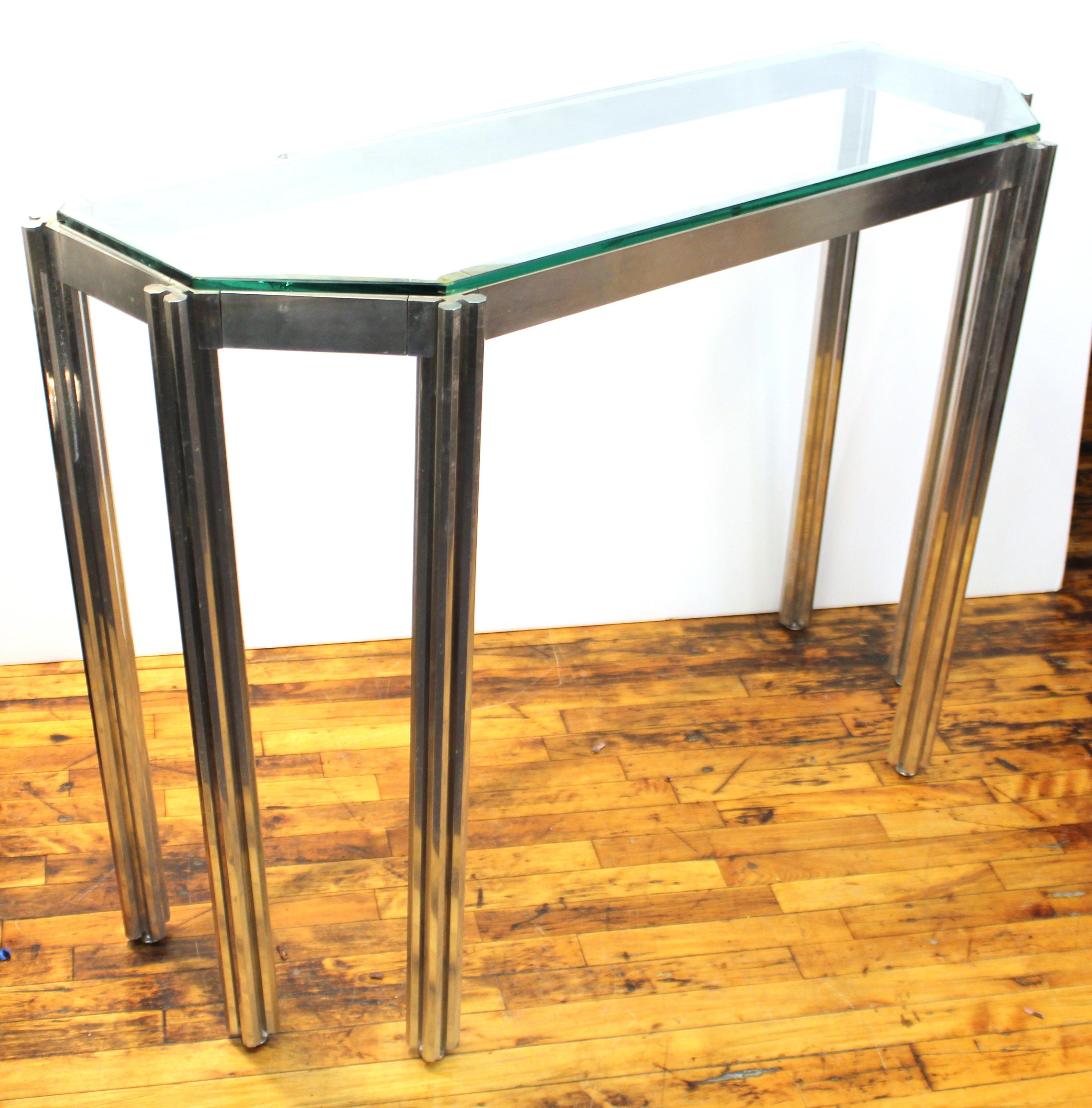 Alessandro Albrizzi Mid-Century Modern console table in chrome and glass. The piece features six legs made up of octagonal bars. The frame is loosely articulated. Wear includes patina to metal appropriate to age and use and a larger chip to the