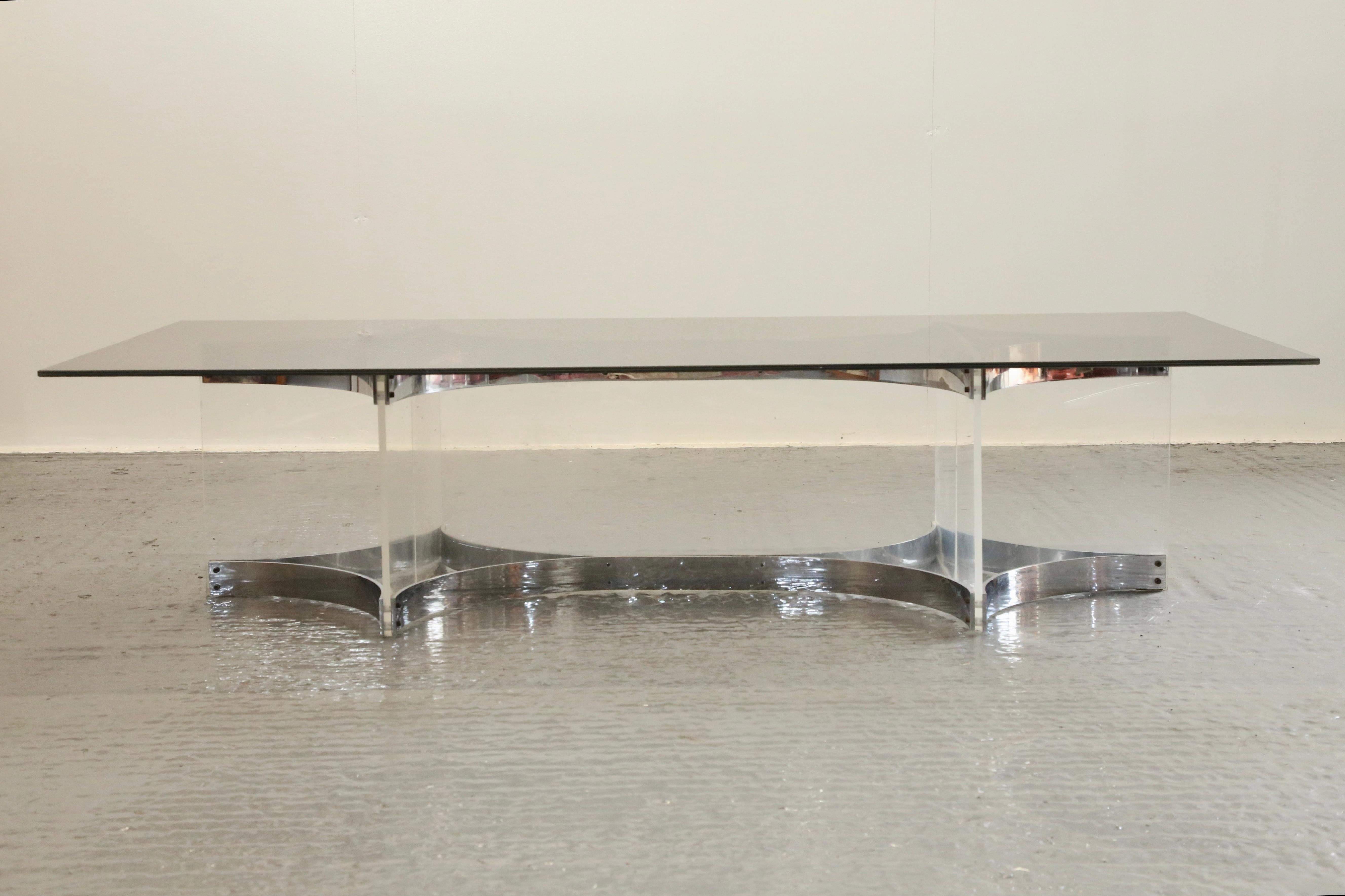 A remarkable Italian Mid Century Modern Coffee Table by Alessandro Albrizzi, finished in chrome plated steel with sculptural curved shapes supporting interlocking lucite sheets. Highly decorative heavy and sturdy base ready. Great condition