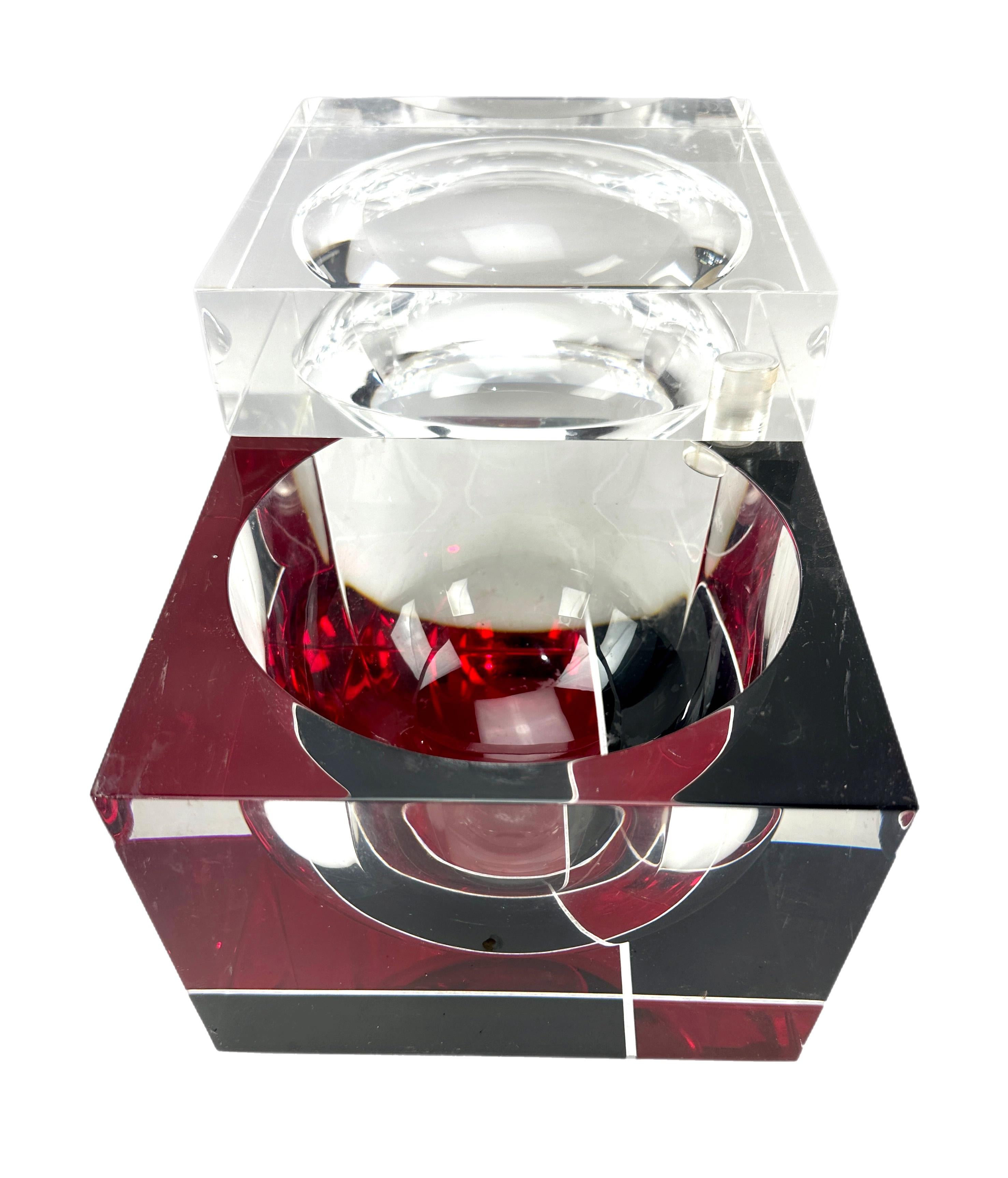 Unusual heavy lucite ice bucket with etched geometric design. 
Striking pattern in red, black, and clear.
Swivel top opens to reveal a suspended floating orb or sphere,
Attributed to Italian designer Alessandro Albrizzi (1934-1994)

