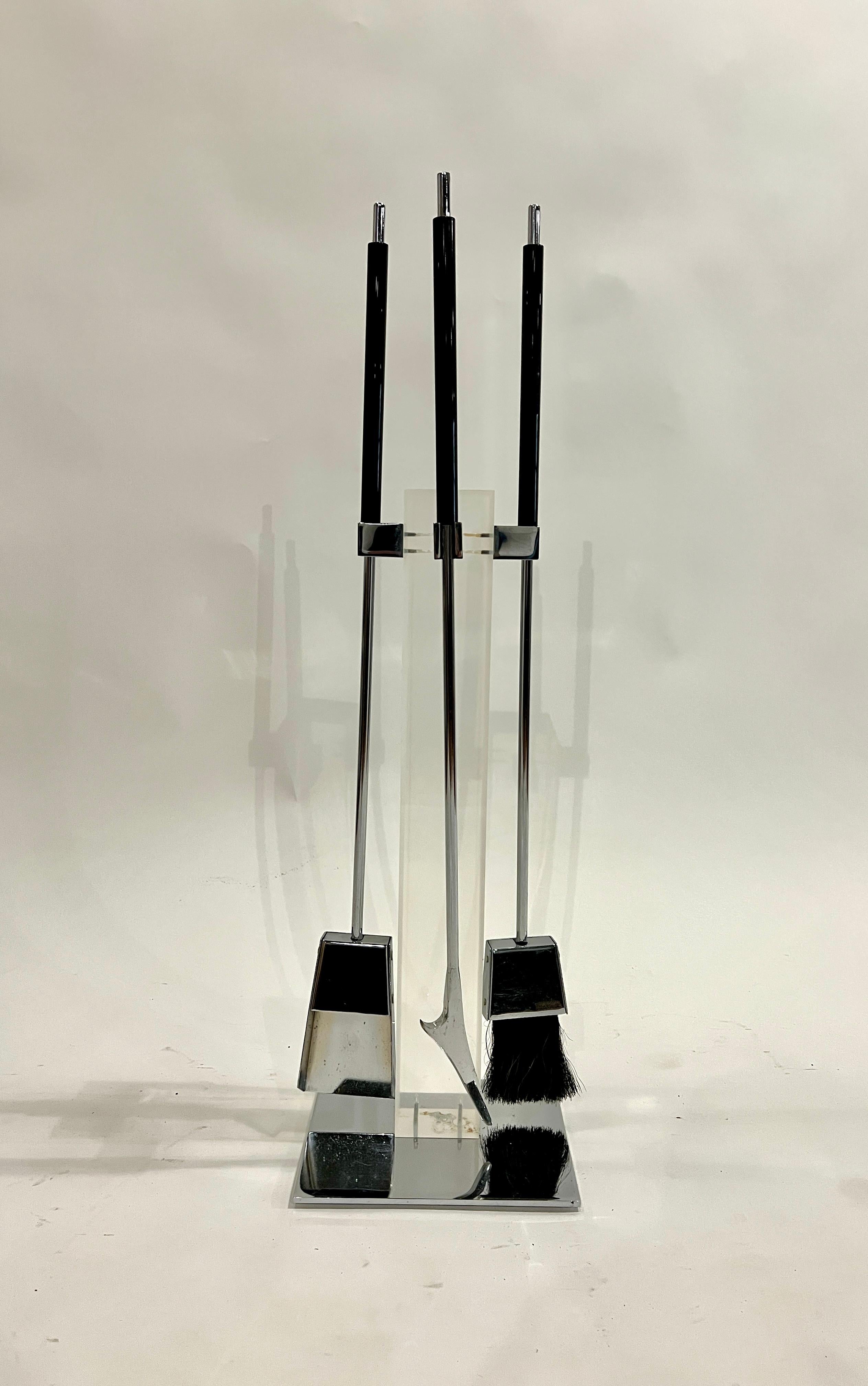 1970's fireplace tool set by Alessandro Arizzi, Italy. The stand is made of a tall lucite post with chrome tools and accents. The chrome is very clean and appears to be unused. 