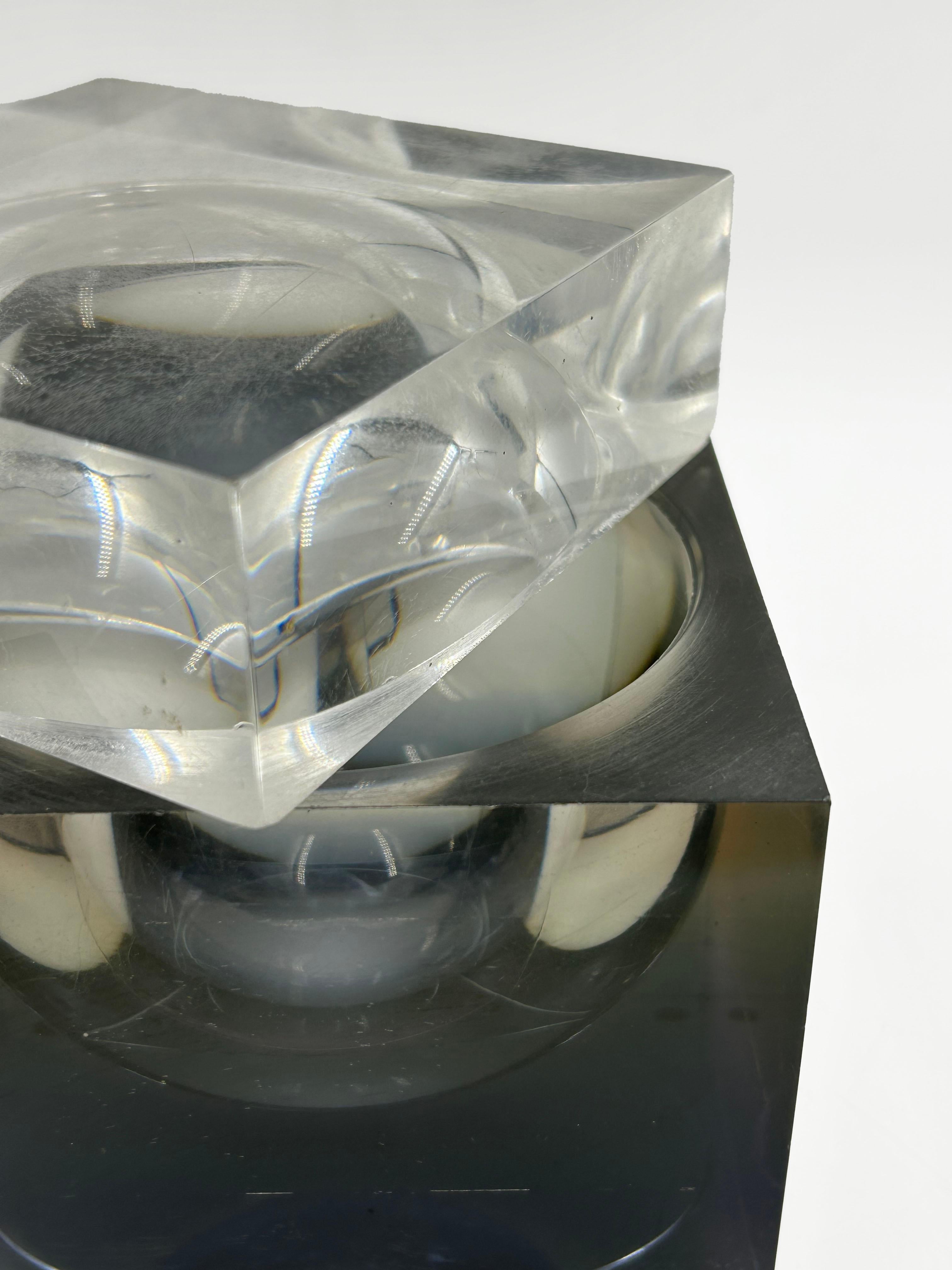 Alessandro Albrizzi Lucite Cube, Italy, 1970s
This Italian design object is a modular, sculptural acrylic (Lucite) cube composed of two stackable sections. The base is a dark or smoky Lucite cube, while the top is a lighter or transparent cube that