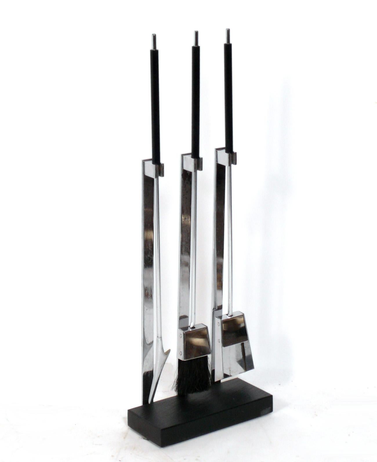 Set of Sculptural Chrome Fireplace Tools, designed by Alessandro Albrizzi, American, circa 1970s. They are constructed of chromed metal with a slate base. Fire tools.