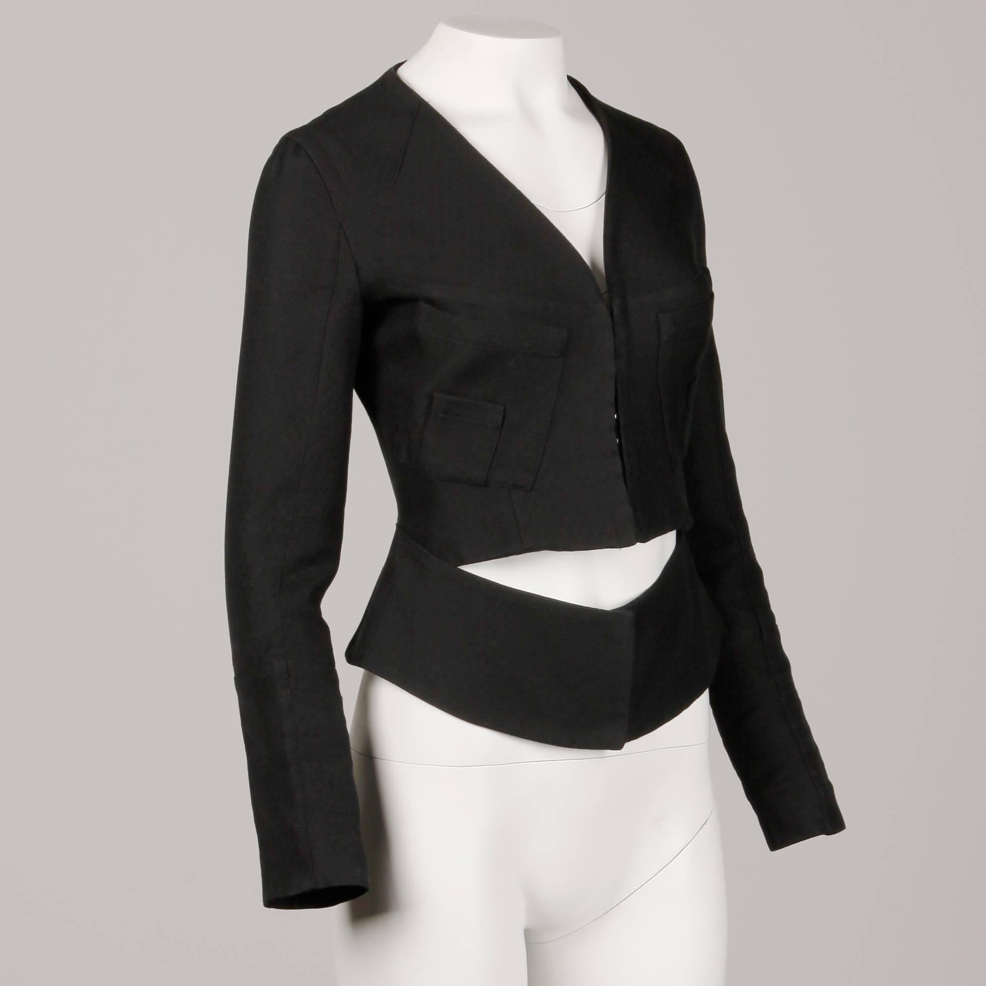 Unique black avant garde blazer jacket by Alessandro Dell'acqua. Unlined with front hook closure. Front patch pockets. 100% cotton. Marked size 40; fits like a size small. The bust measures 36