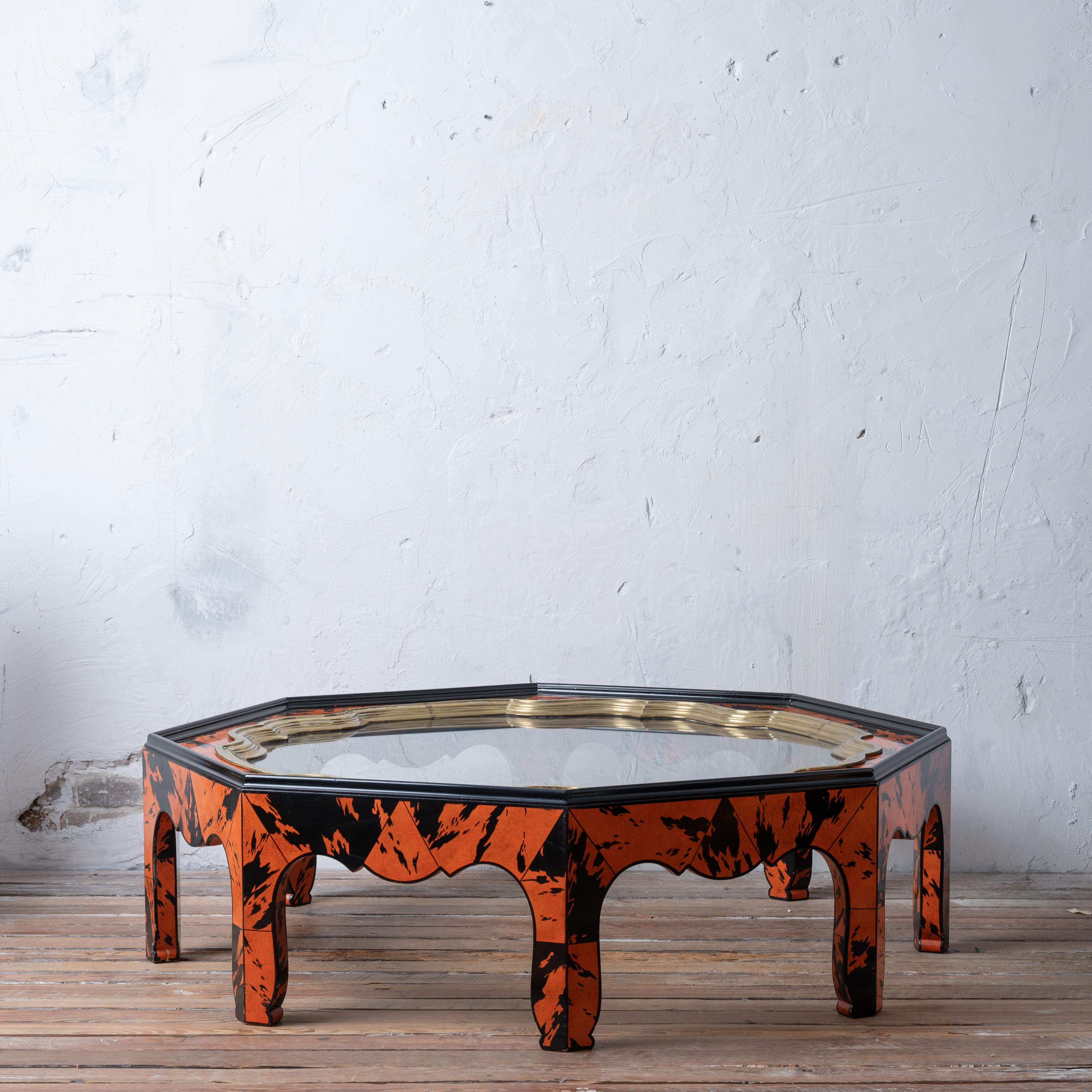 A striking octagonal coffee table with an abstract orange and black faux tortoiseshell lacquered finish by Alessandro Gabrielli Gambalogna for Baker, circa 1980.

Quatrefoil brass lined glass top is removable. 

53 inches wide by 48 ¾ inches deep by