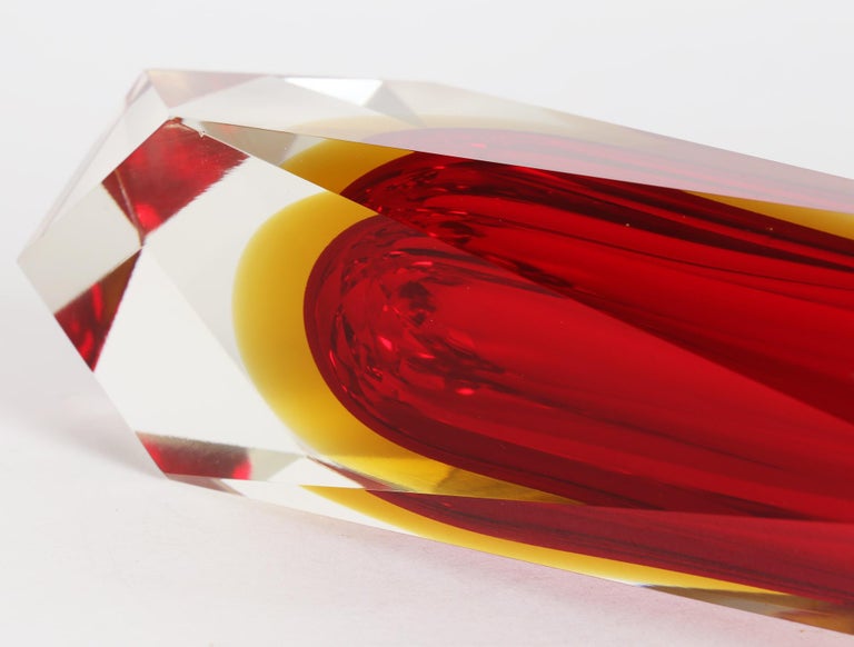 A very striking Italian Murano facet cut sommerso art glass vase by Alessandro Mandruzzato dating from around 1960. This exceptional and heavily made clear glass vase has a bright red centre with a yellow halo. The glass catches the light from every