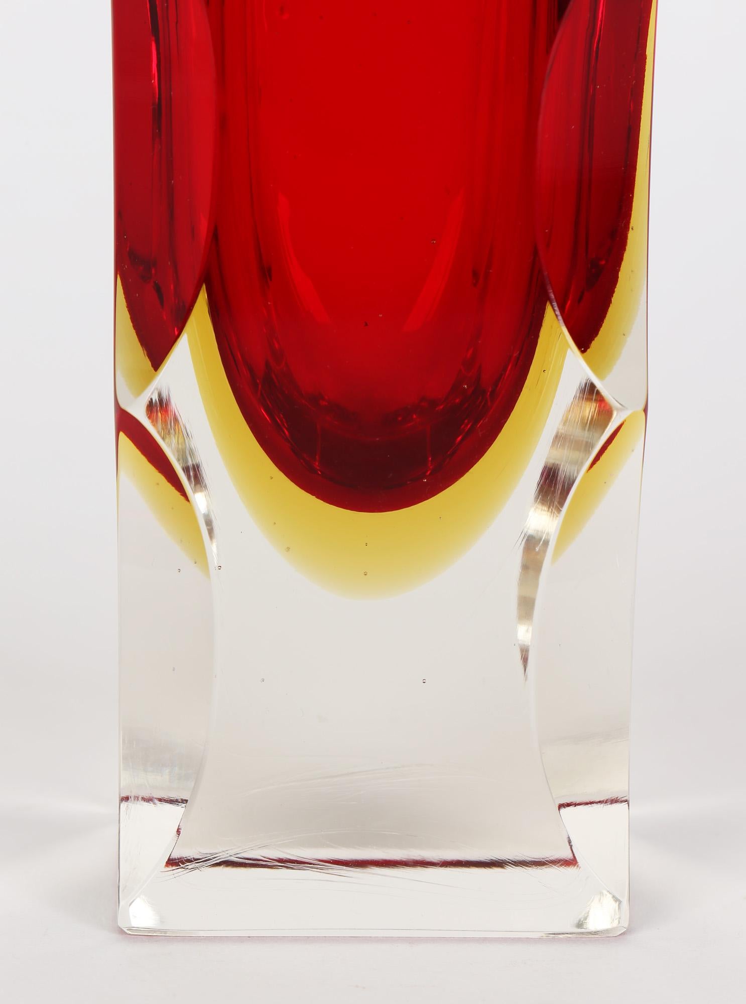 A large and unusual striking Italian Murano sommerso art glass vase with facet cut edges by Alessandro Mandruzzato dating from around 1960/70. This exceptional and heavily made square shaped clear glass vase has a bright red centre with a yellow