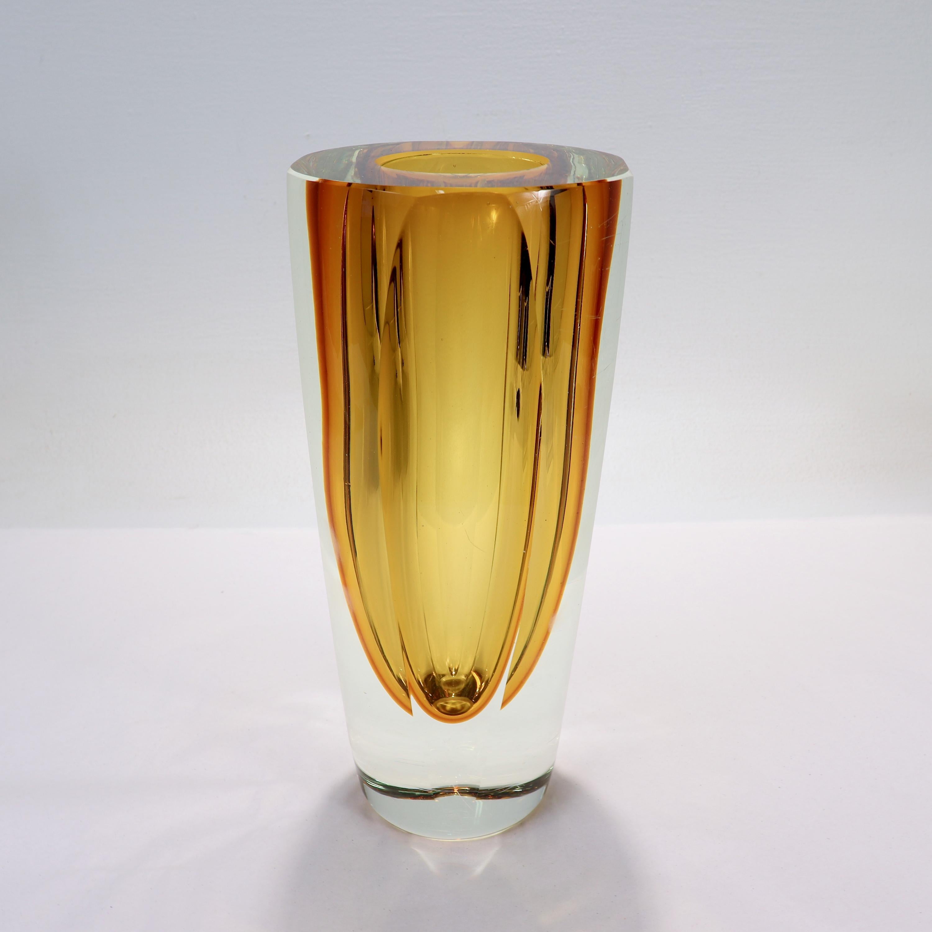 A fine Mid-Century Murano art glass vase.

Attributed to Alessandro Mandruzzato.

With a thick walled yellow sommerso technique center in a tapered and faceted clear glass body.

A wonderful Mid-Century Murano glass vase!

Date:
Mid-20th