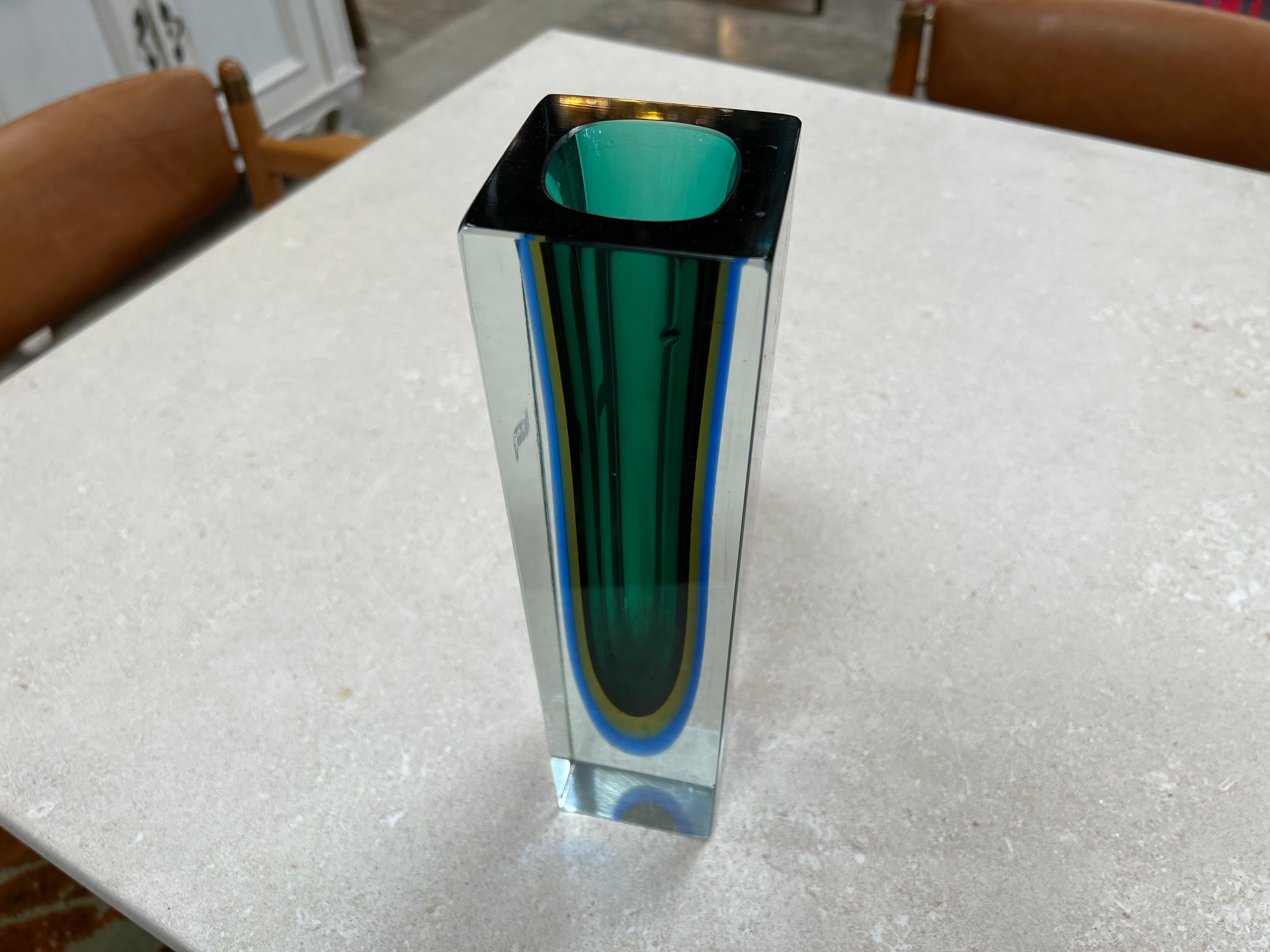 The Alessandro Mandruzzato Vintage Murano Vase from the 1970s is a highly sought-after piece of art glass. Crafted in a stunning shade of purple, this vase is characterized by its exceptional craftsmanship and distinctive design. The rarity of this