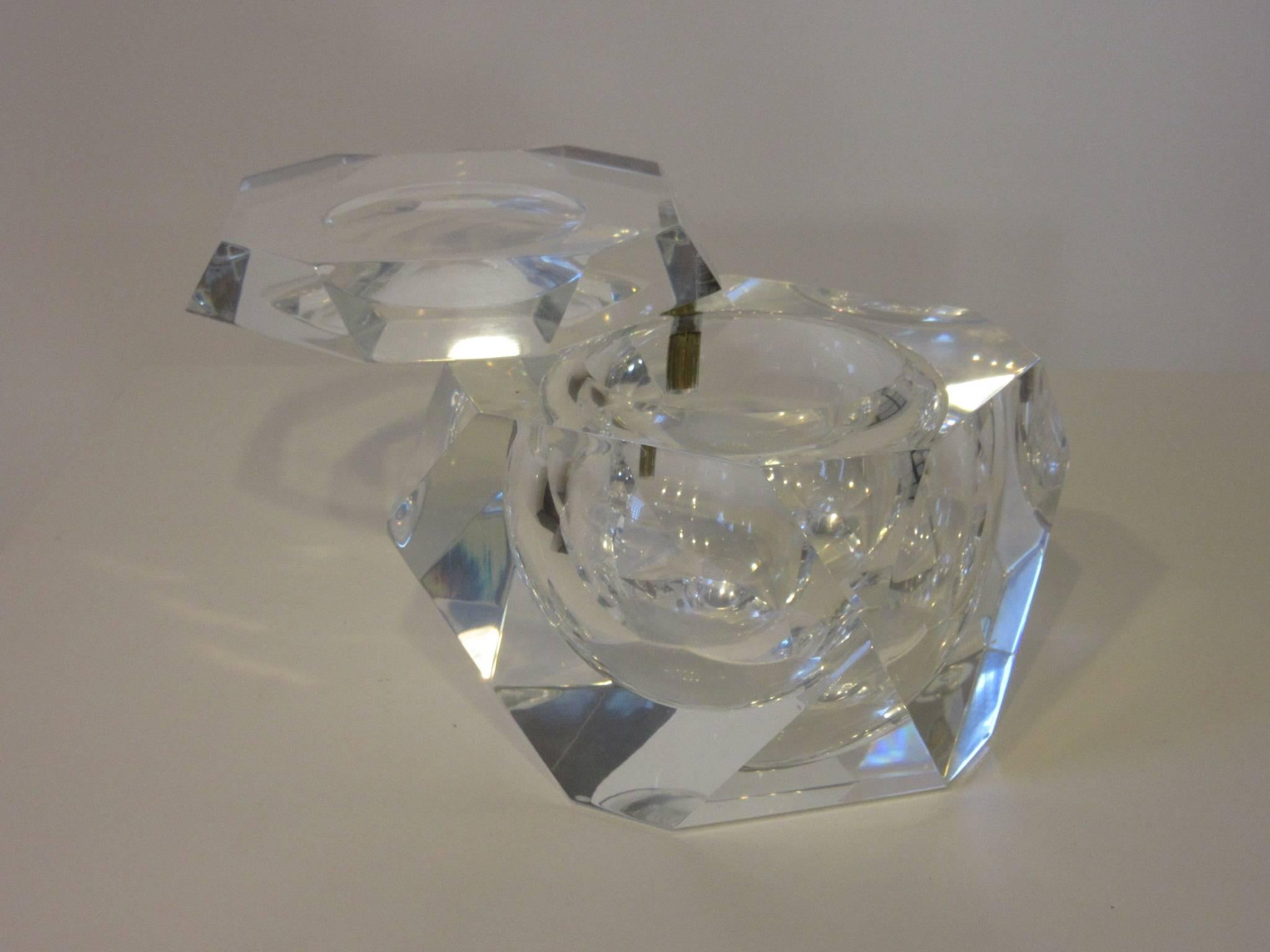 A beautifully faceted Lucite ice bucket or candy container with swiveling lid and brass machined hinge pin. The inside is perfectly bowled out measuring 7