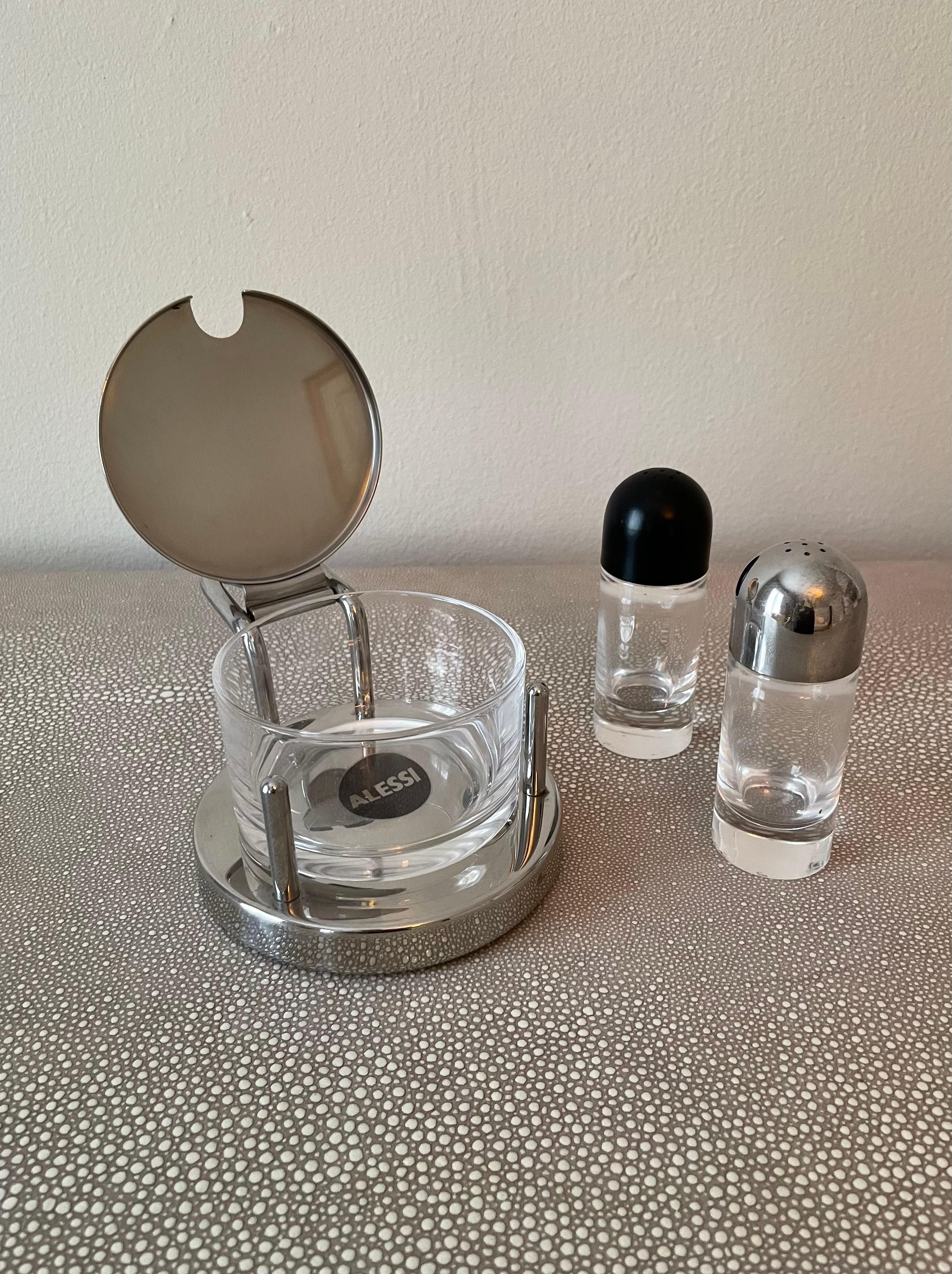 Sleek salt, pepper sugar set made in Italy by Alessi. Add sleek Italian cafe style to any table. The 'sugar' canister can be used for a variety of spices, perhaps even red pepper flakes. The set polishes quickly and easily to catch the afternoon