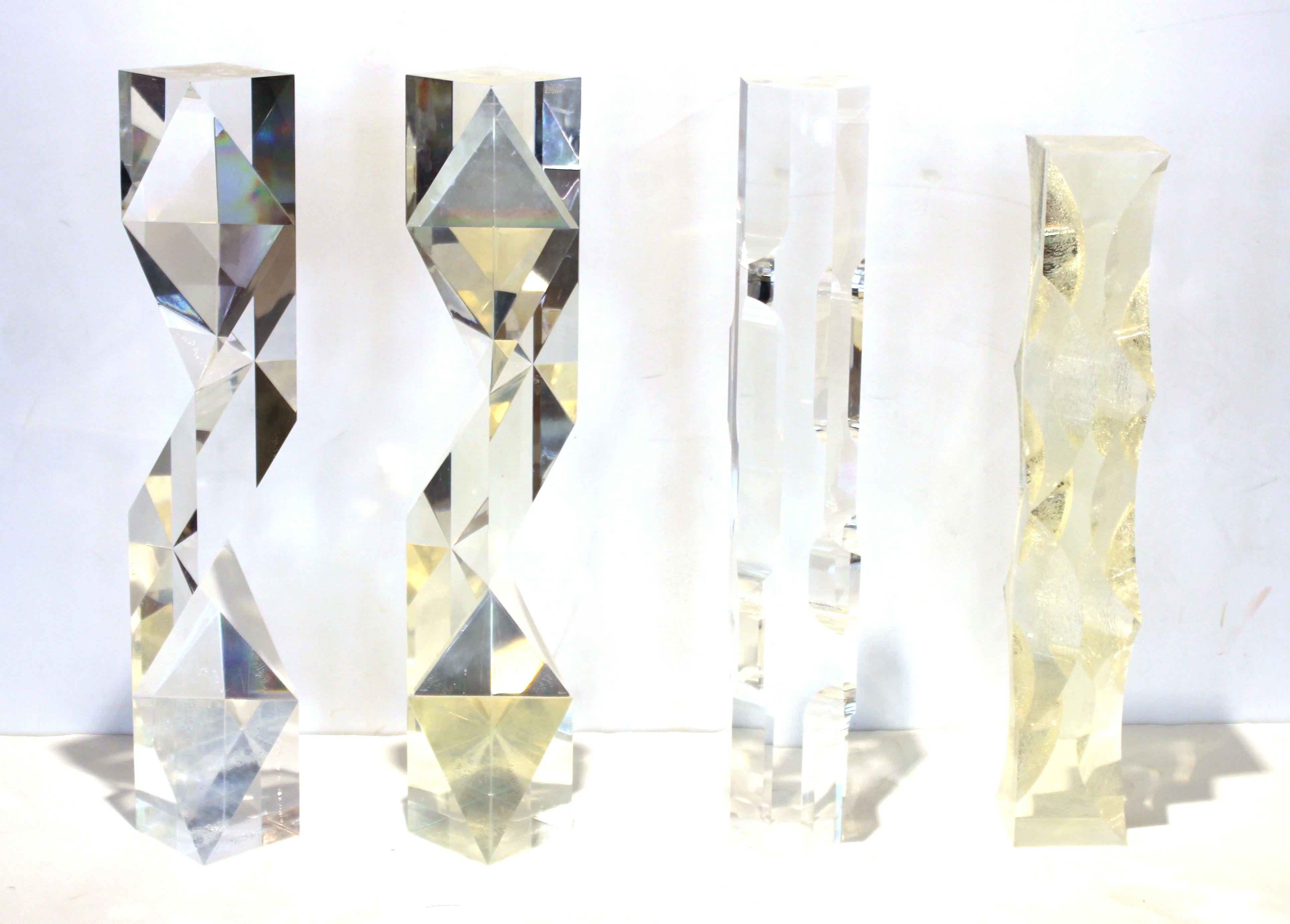 Italian modern set of four 'Fusina' prism sculptures in abstract geometric shapes, designed by Alessio Tasca. The set is made of Lucite and can be arranged in multiple ways for display. Made in the 1970s, the set is signed 'Tasca' in the corner of