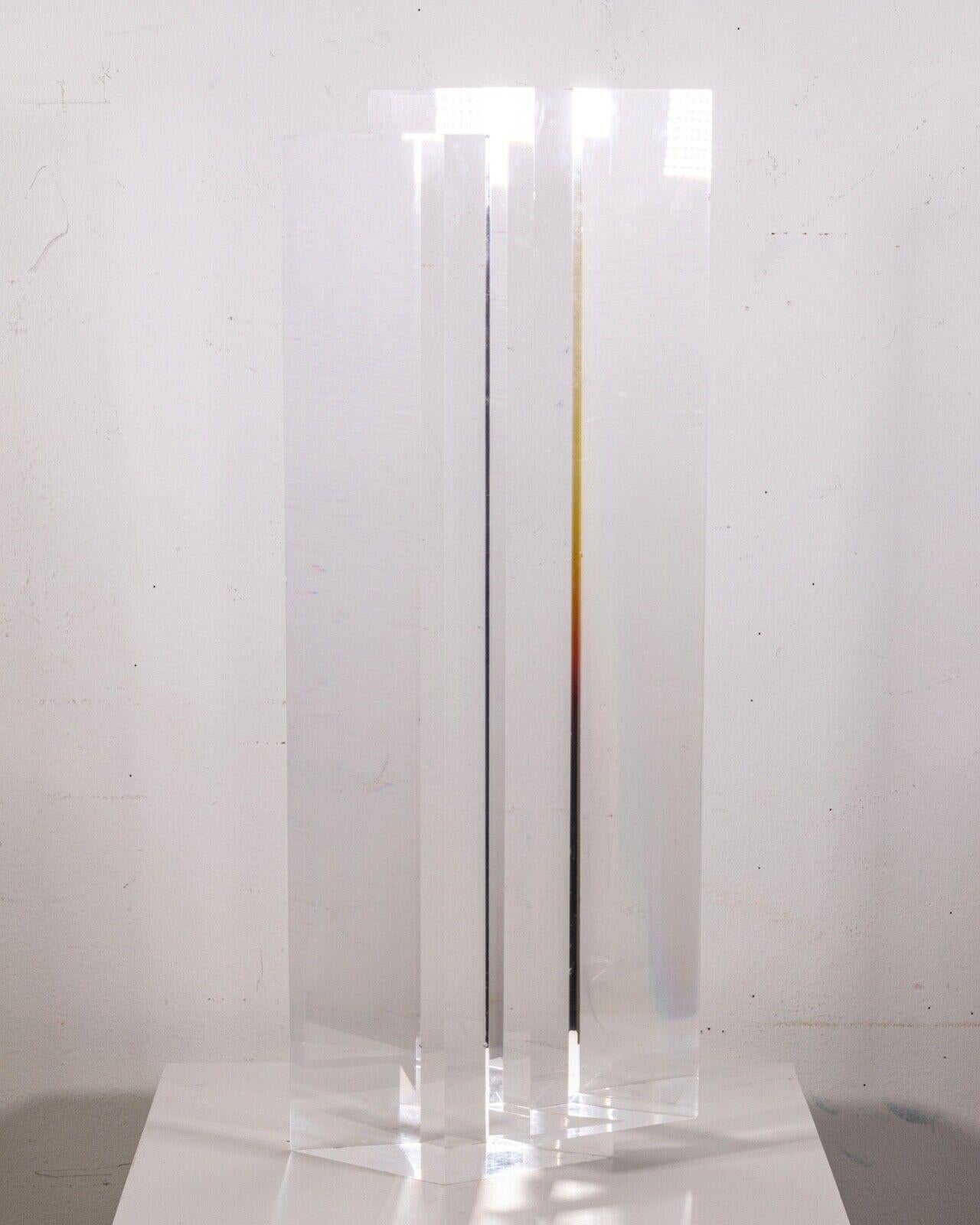 A unique monolithic lucite prism postmodern contemporary tower sculpture by Alessio Tasca. Etched signature on the side. Circa late 1970s early 1980s. An elegant minimal sculpture that compliments any modern or contemporary space. Tasca is a