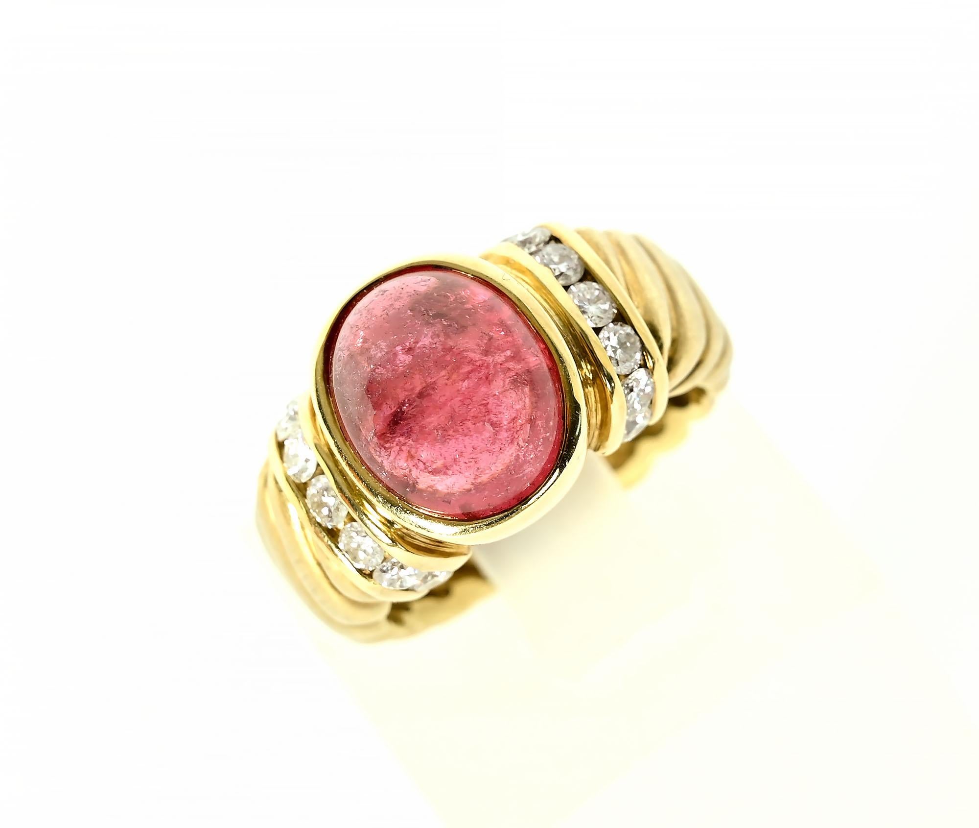 Simple but dressy tourmaline and diamond 14 karat gold ring by Aletto Brothers. The central oval tourmaline measures 1/2