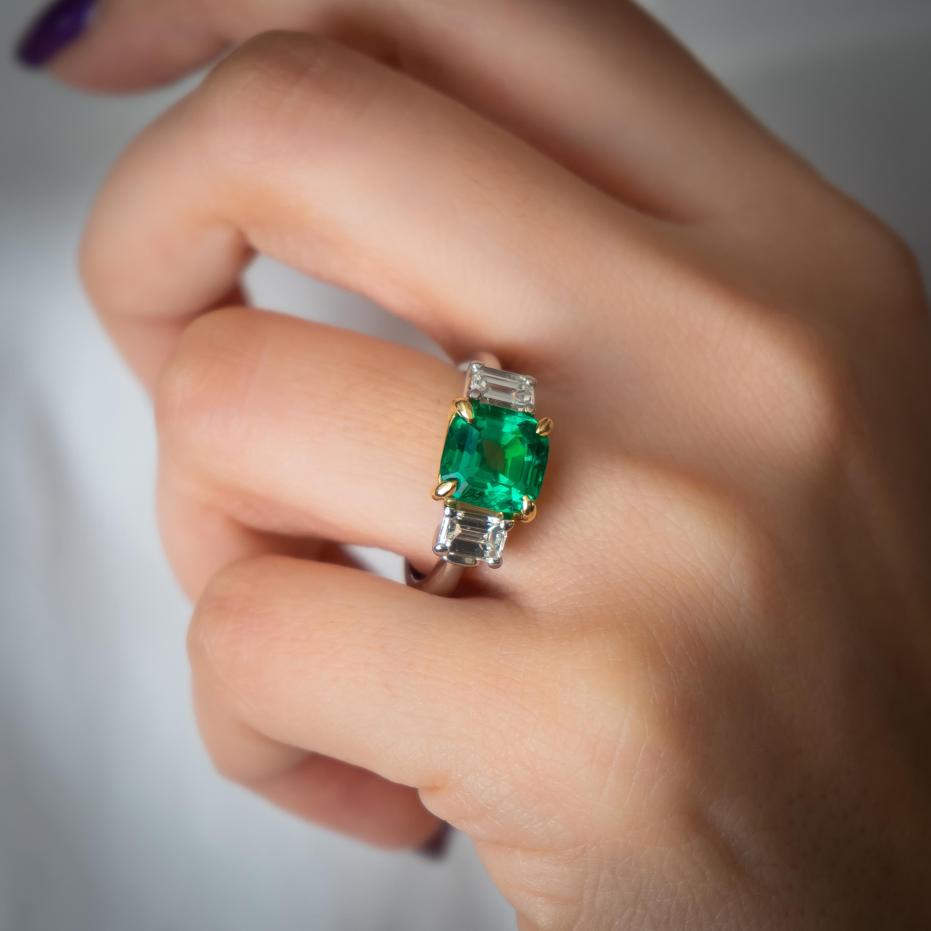 A Colombian emerald and diamond ring, set with a 2.40ct cushion shaped step-cut emerald, in an 18ct yellow, gold four-claw setting, accompanied by GIA certificate 5172407807, stating that the emerald shows characteristics of Colombian origin and no