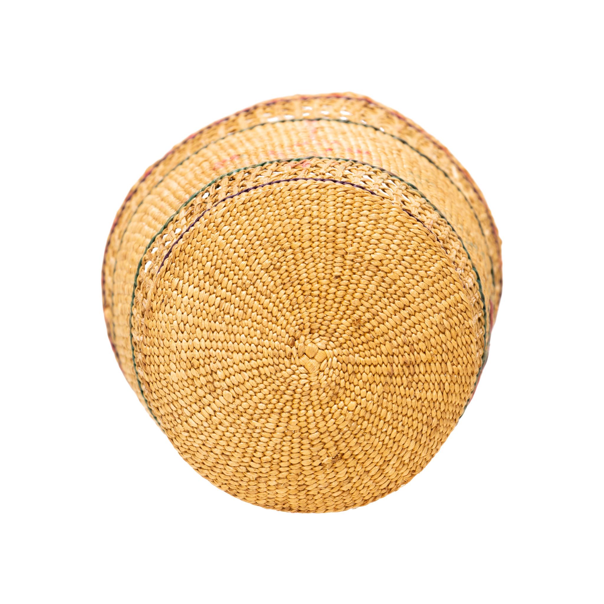 Native American Aleut basket. Finely woven basket with tight weaving in center and beautiful embroidered pink/rose floral design. Top and bottom are a loose, open weave. Exceptional piece, great for display in a coastal cabin or handmade indigenous