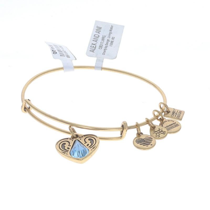Brand: Alex and Ani  
Style Number: CBD17LWRG
Charity: Living Water International
Metal: Gold Toned (Rafaelian finish)
Stone: Blue Swarovski Crystal 
Size: Adjustable Fit

Condition: New with Tags & Card

We have been dealing in fine new, vintage,